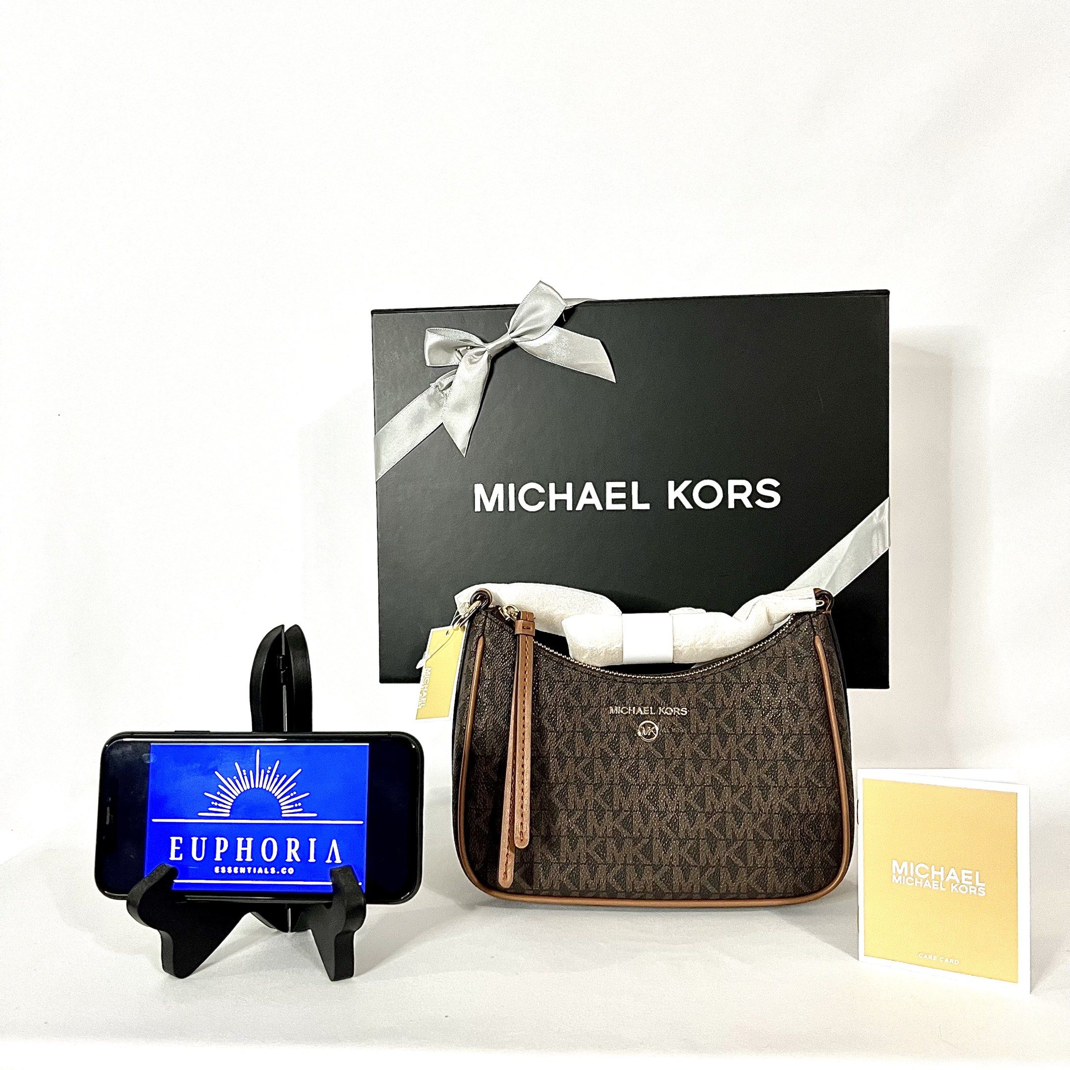 MK Jet Set Charm Small Logo Pochette (Category: Luxury Bags & Wallets) located in Valenzuela. Submitted by euphoriaessentials.co (Listing ID 1417012151, Image 1). Description: MK Jet Set Charm Small Logo Pochette On hand and Ready to Ship / Lalamove Color: Brown Description: • Shoulder bag • Logo-print canvas • 69% coated canvas/17% polyester/13% cotton/1% polyurethane • Trim: 100% leather • Gold-tone hardware • 8”W X 6”H X 3”D • Handle drop: 8.5