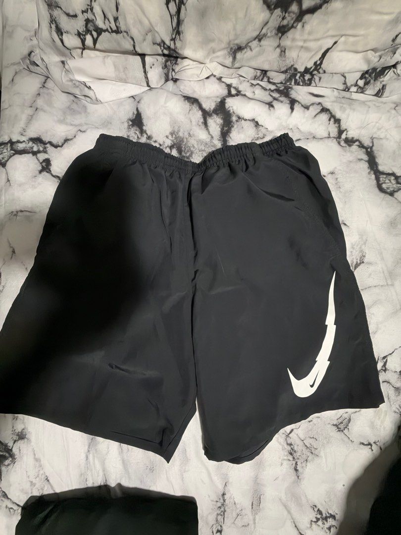 Nike running shorts (Category: Shorts) located in Quezon City. Submitted by jaypee0 (Listing ID 1416845959, Image 1). Description: - Black Nike shorts - White Nike logo on left leg - Elastic waistband - Lightweight material - Ideal for athletic activities or casual wear.