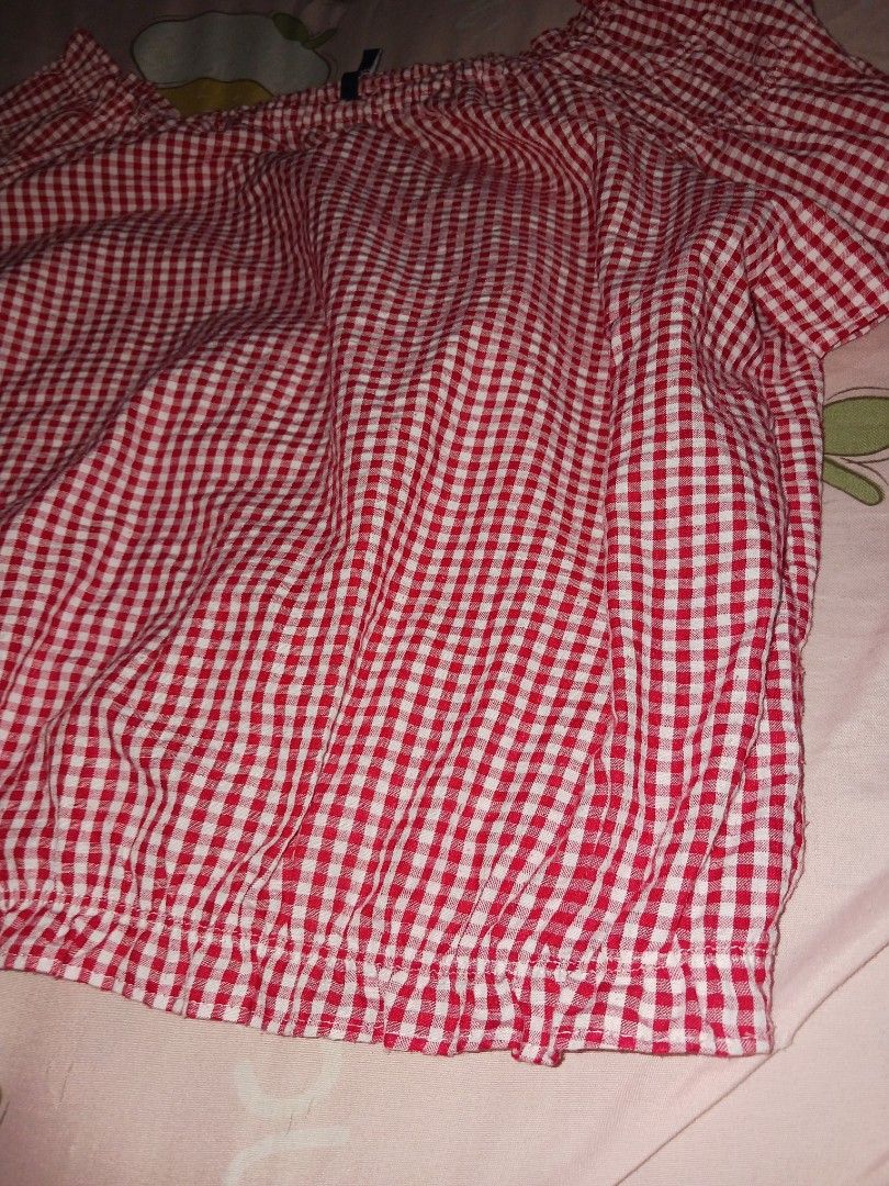 Red Gingham Off-Shoulder Top (Category: Blouses) located in Naga. Submitted by havenaid (Listing ID 1416884916, Image 3). Description: - Classic red and white gingham pattern - Off-shoulder design - Short sleeves - Ruffled neckline and hem - Comfortable, gathered/elasticized fit - Dress up or down Classic off-shoulder gingham top in red and white. Features a garterized neckline and elastic hem, giving a comfy fit while still looking flattering. L