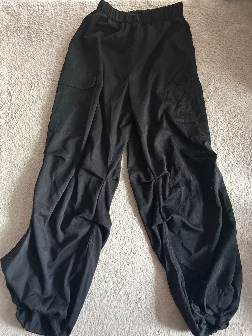 Shein Petite M Black Cargo Pants (Category: Other Bottoms) located in Taguig. Submitted by rcdeclutter (Listing ID 1416921704, Image 1). Description: - Shein black cargo pants - Size: Petite M - Features: Elastic waistband, two cargo pockets - Material: Polyester - Fit: Relaxed - Fabric: Lightweight - Perfect for casual wear.