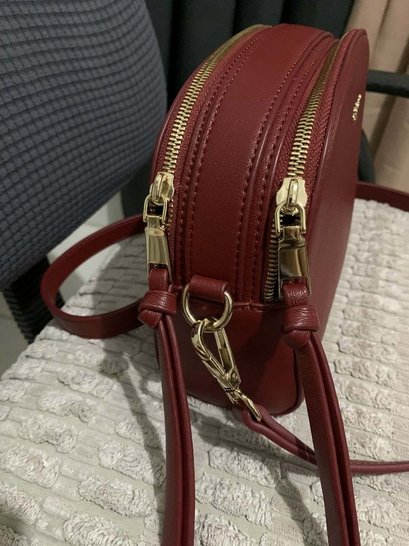 St. Scott London Crossbody Bag (Category: Cross-body Bags) located in Marikina City. Submitted by rafmorales (Listing ID 1416924664, Image 2). Description: ang pretty in person , unused. stored properly :) shadows lang po ang nasa hardwares good as new :) - original St. Scott London Crossbody Bag - Rich red color - Gold-toned hardware - Dual-zippered main compartment - Adjustable strap - Minimalist design - Stylish and practical for everyday use.