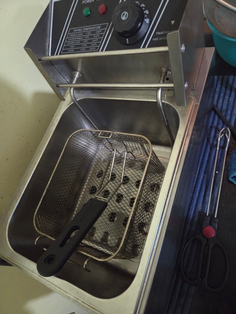 Stainless Steel Deep Fryer (Category: Fryers) located in Manila. Submitted by cluttersister (Listing ID 1416920305, Image 2). Description: Stainless steel deep fryer with a thermostat control. Includes a frying basket and a power indicator light. The unit has a removable heating element and a lid. The power cord is included. RFS cluttering di na nagamit for business last price na po.