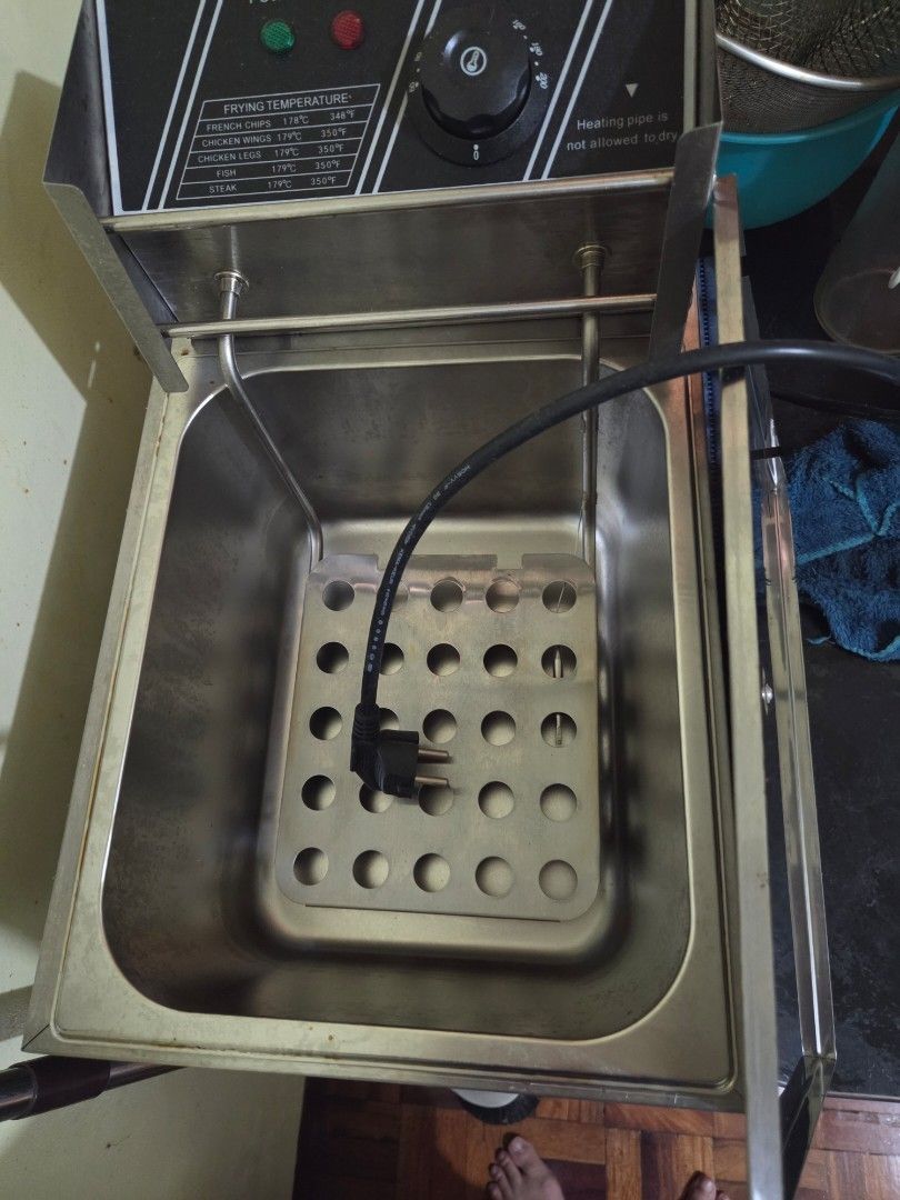 Stainless Steel Deep Fryer (Category: Fryers) located in Manila. Submitted by cluttersister (Listing ID 1416920305, Image 3). Description: Stainless steel deep fryer with a thermostat control. Includes a frying basket and a power indicator light. The unit has a removable heating element and a lid. The power cord is included. RFS cluttering di na nagamit for business last price na po.