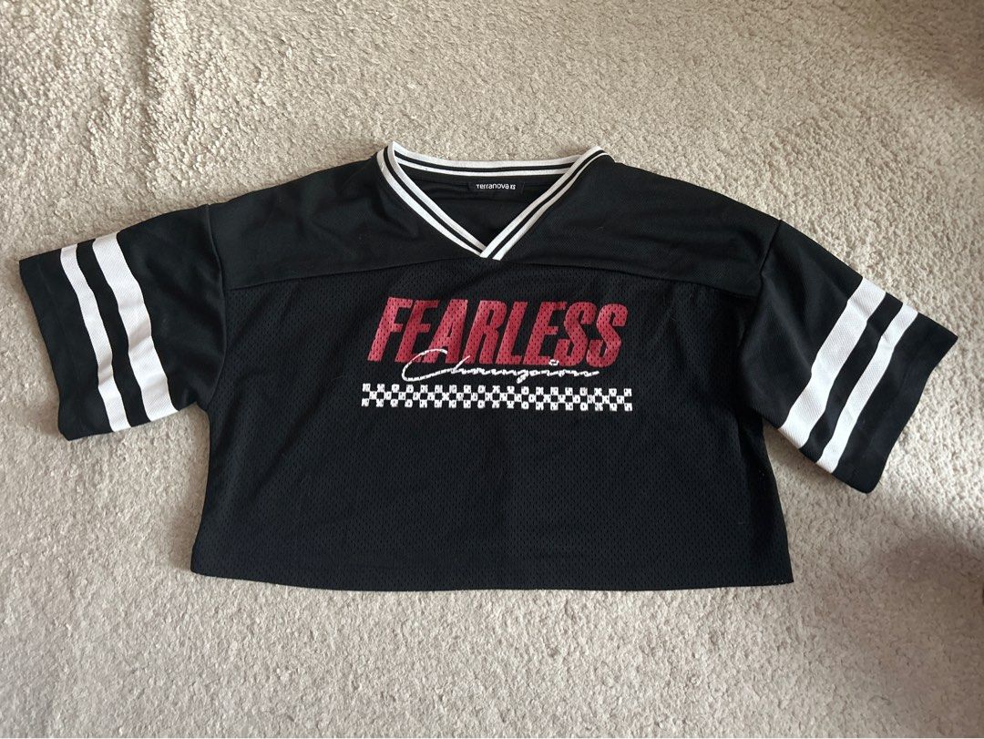 Terranova Fearless Top XS (Category: Sleeveless) located in Taguig. Submitted by rcdeclutter (Listing ID 1416915868, Image 1). Description: - Terranova black top - "FEARLESS" print on front - V-neck design - White stripes on collar and sleeves - Size: XS - Mesh-like texture.