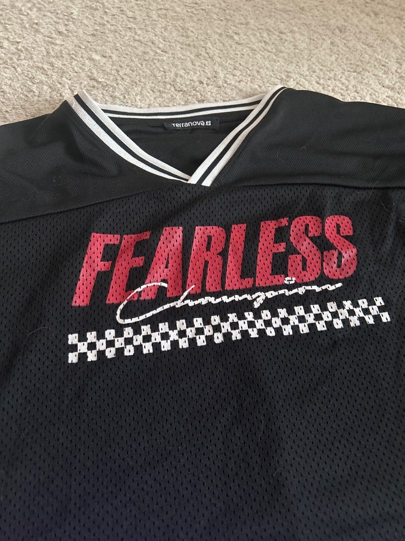Terranova Fearless Top XS (Category: Sleeveless) located in Taguig. Submitted by rcdeclutter (Listing ID 1416915868, Image 2). Description: - Terranova black top - "FEARLESS" print on front - V-neck design - White stripes on collar and sleeves - Size: XS - Mesh-like texture.