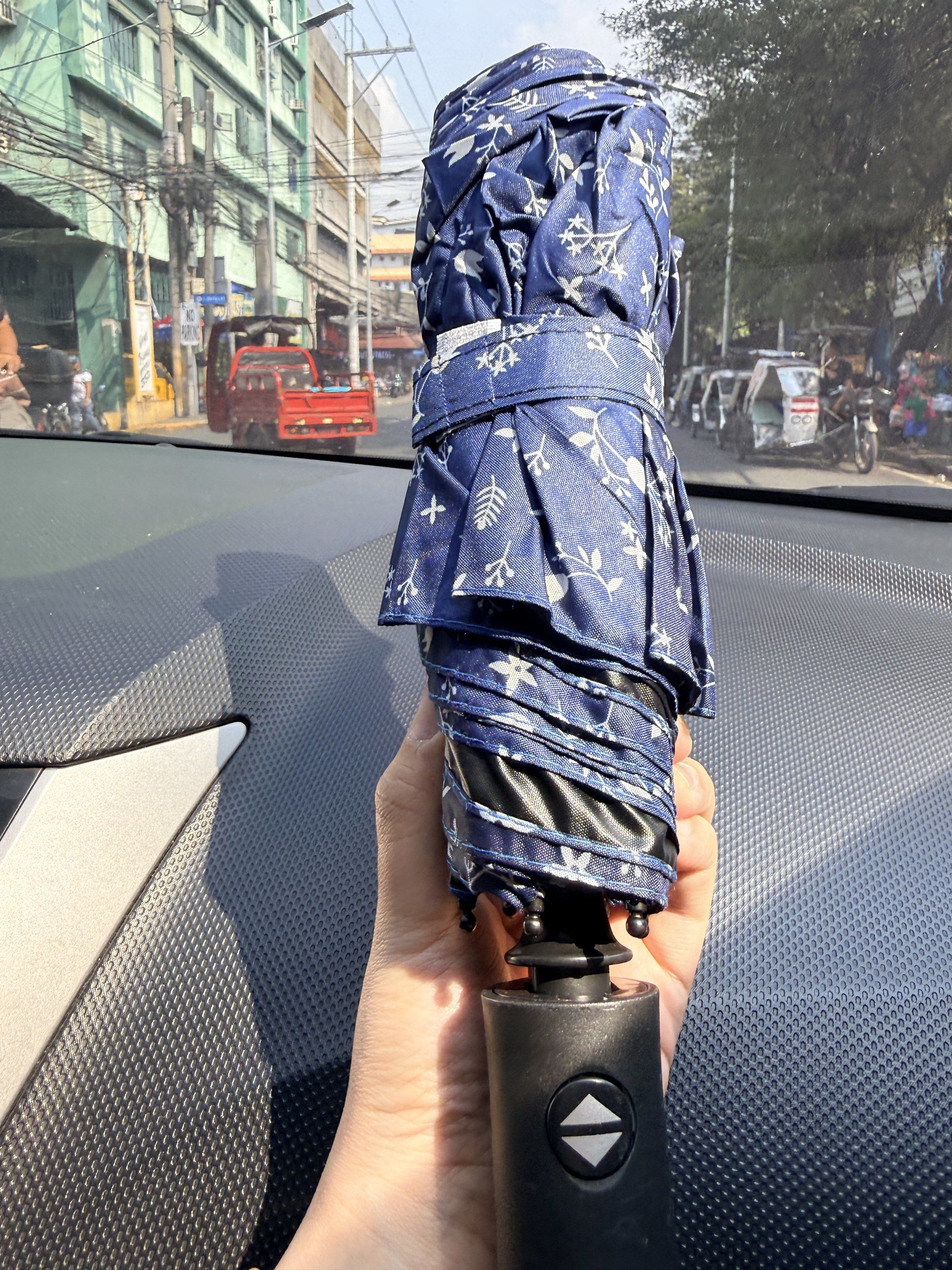 UV Protection Folding Umbrella (Category: Umbrellas) located in Manila. Submitted by hpshop2020 (Listing ID 1416915872, Image 3). Description: - UV Protection - Black handle with easy open/close button - Available Colors/Patterns: Blue floral, beige, black, and more! - Compact and easy to carry - Perfect for sun protection.