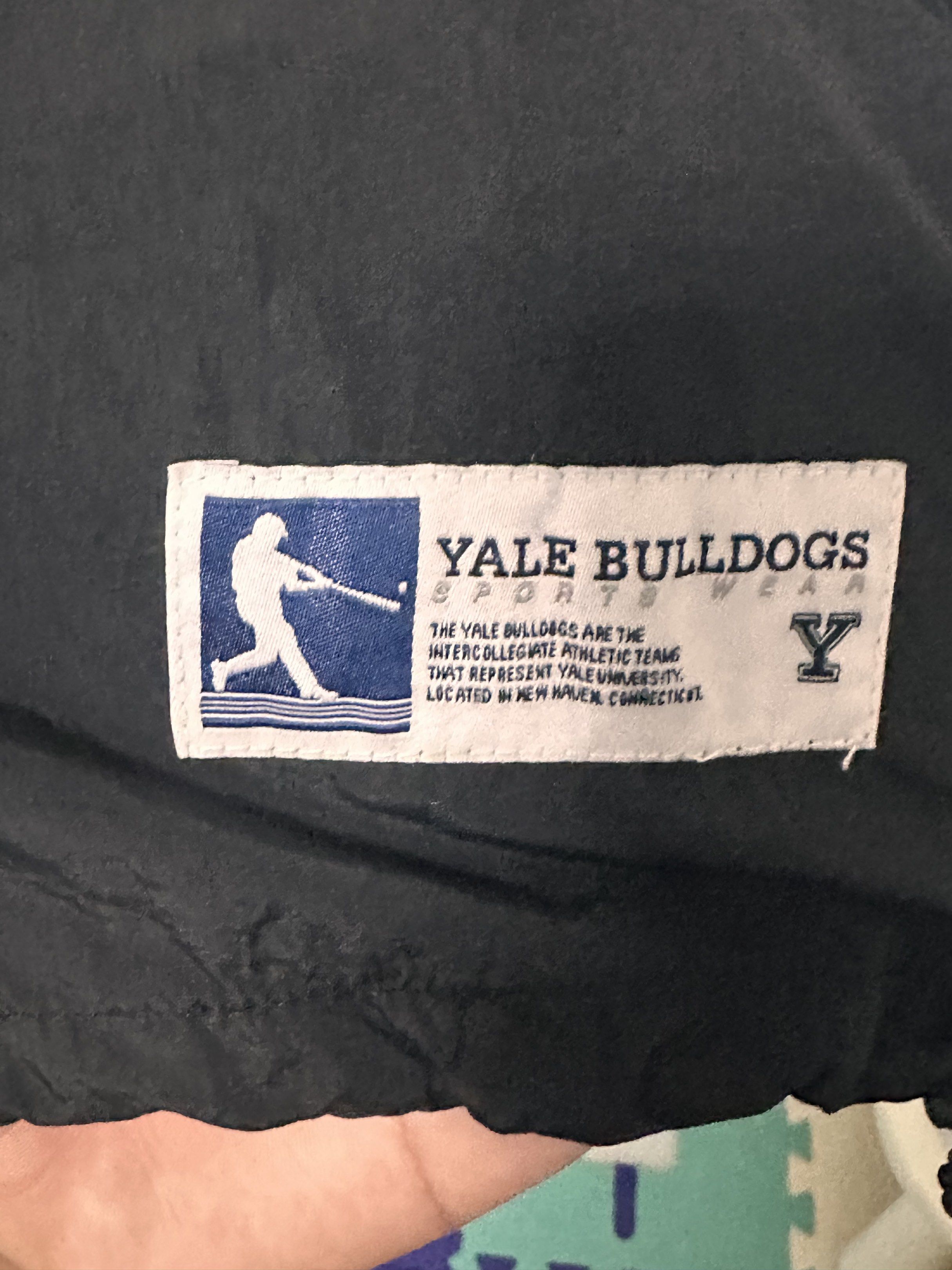 Yale Black Jacket - Size S (Category: Coats, Jackets and Outerwear) located in Manila. Submitted by 404archive_ (Listing ID 1416880670, Image 3). Description: - Yale black jacket - Size: S - Design: V-neck with white stripes on collar - Material: Smooth, possibly nylon-like - Features Yale brand label.