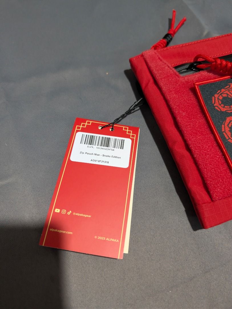Alpaka Zip Pouch Max - Snake Edition (Category: Belt bags, Clutches and Pouches) located in Quezon City. Submitted by trainforless (Listing ID 1417144236, Image 3). Description: Condition: Never been used Negotiable :) RFS: Decluttering 📦: Lalamove or J&T 💵: GCash, BPI, Seabank Alpaka Zip Pouch Max is a Year of the Snake edition. It features a red exterior with a black zipper and accents. The pouch has multiple compartments inside, including a 