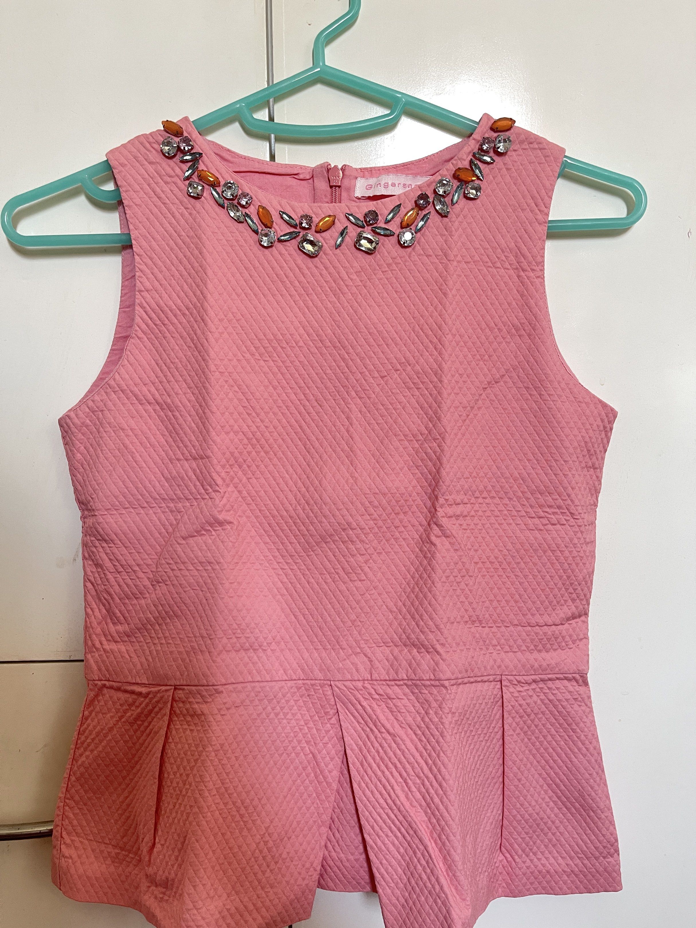 Gingersnaps - Kids Embellished Pink Top (Category: Babies & Kids Fashion) located in Manila. Submitted by closetlibraryph (Listing ID 1417090554, Image 1). Description: - Gingersnaps pink top - Unique quilted texture - Round neckline with sparkling embellishments - Sleeveless design - Stylish peplum hem - Back zipper closure - Perfect for a touch of elegance.