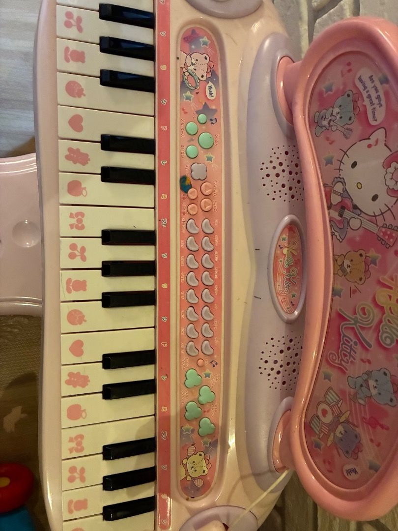 Hello Kitty Electronic Keyboard Piano (Category: Musical Instruments) located in Pasay City. Submitted by snowsnow161581 (Listing ID 1417031241, Image 2). Description: - Kitty themed electronic keyboard. - Pink design with Kitty graphics. - Includes small chair. - Features multiple sound options. - Plays pre-recorded melodies. - Ideal for young children..