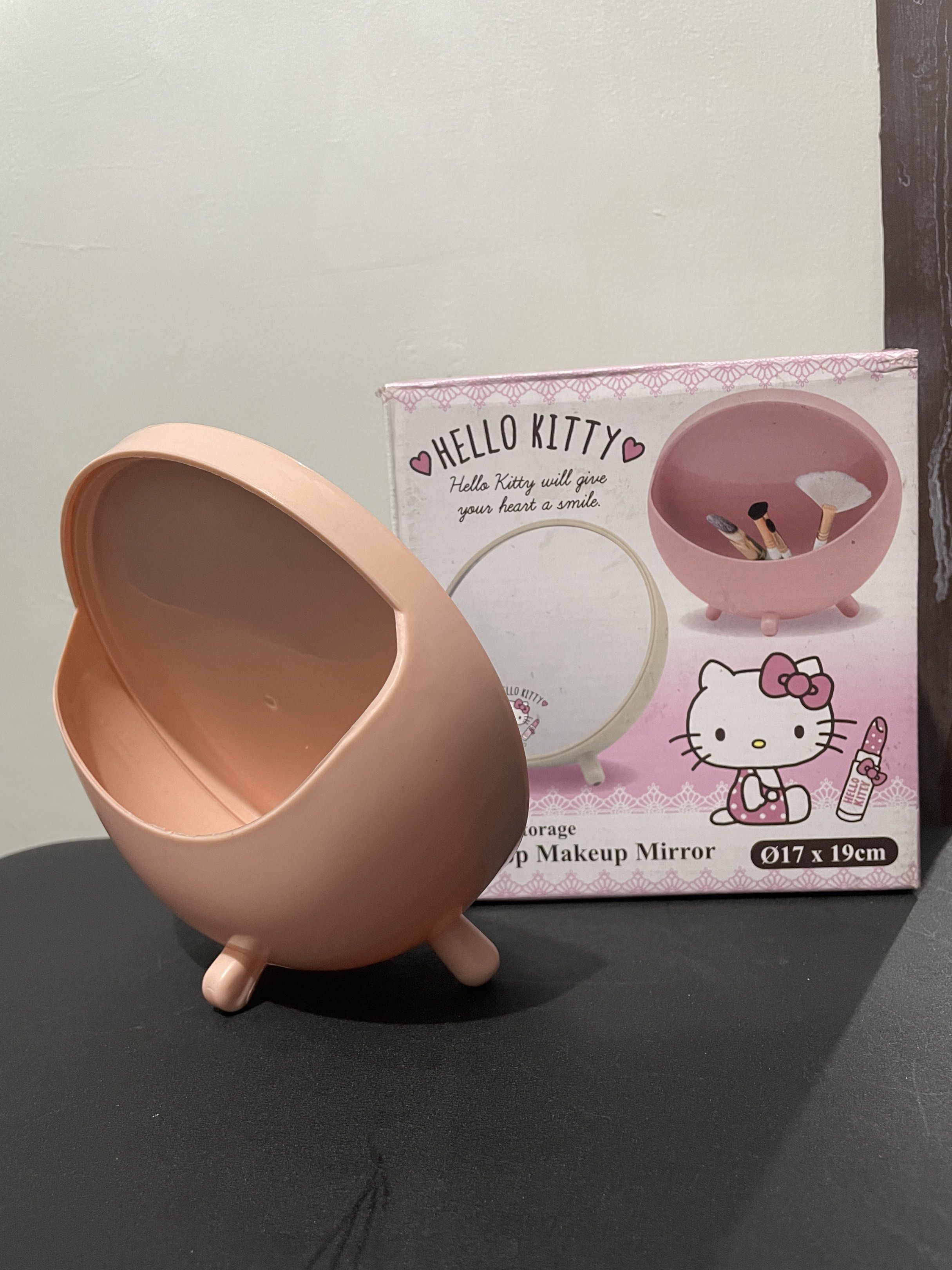 Hello Kitty Makeup Mirror with Storage (Category: Makeup) located in Taytay. Submitted by annequeen88 (Listing ID 1417145931, Image 2). Description: - Kitty makeup mirror with a charming design. - Round mirror with a pink frame and Kitty graphic. - Includes a matching pink storage container. - Perfect for brushes and small items. - Dimensions: 17 x 19 cm..
