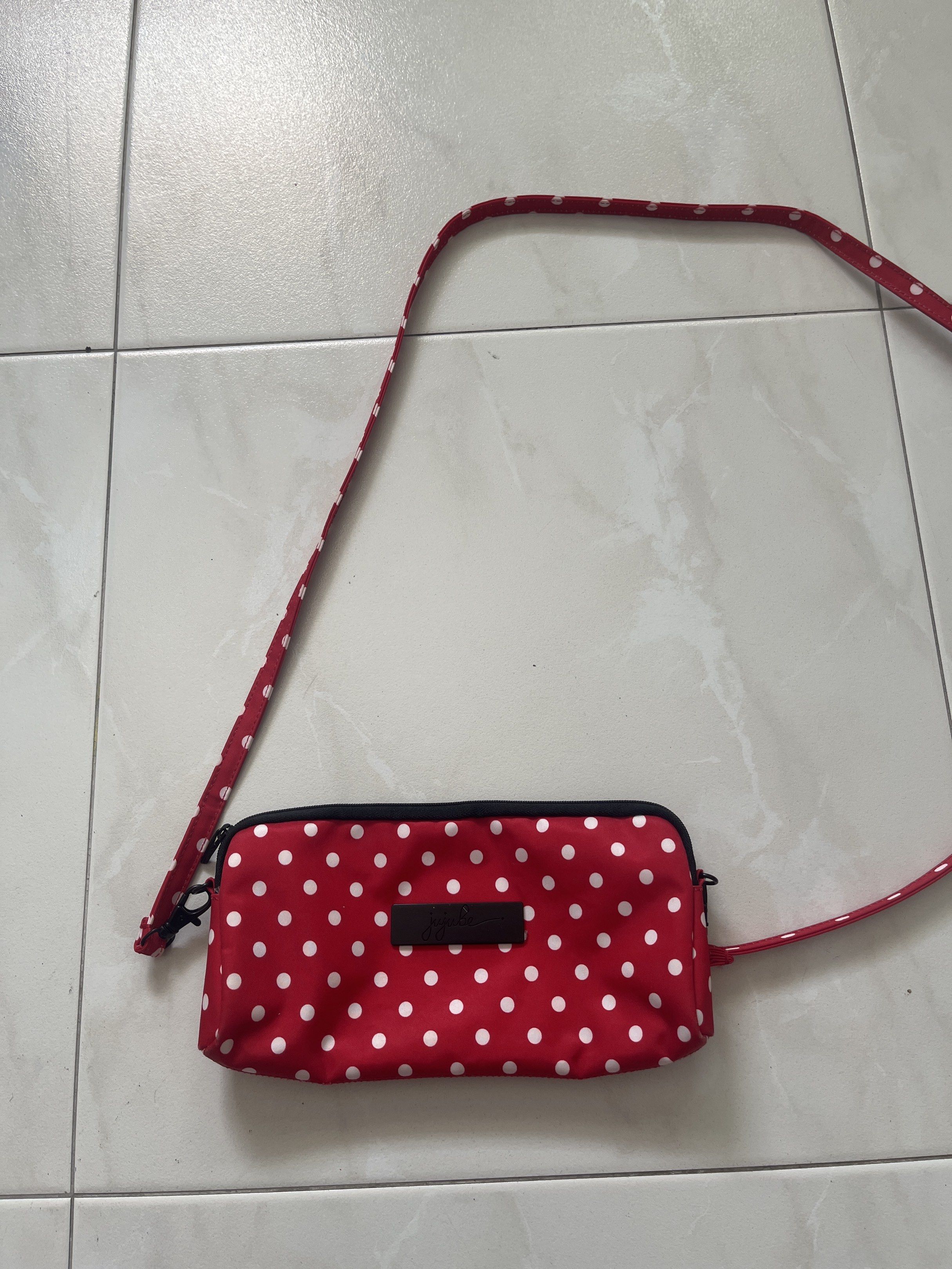 Jujube be quick red ruby (Category: Diaper Bags & Wetbags) located in Singapore. Submitted by rosie_cloud (Listing ID 1415255630, Image 2). Description: - Red strap - White polka dots - Black clasp Just one in its own. Comes with the long crossbody strap and the short hand carry strap. Self collect at my block near Mayflower TEL. Dm for more details. .