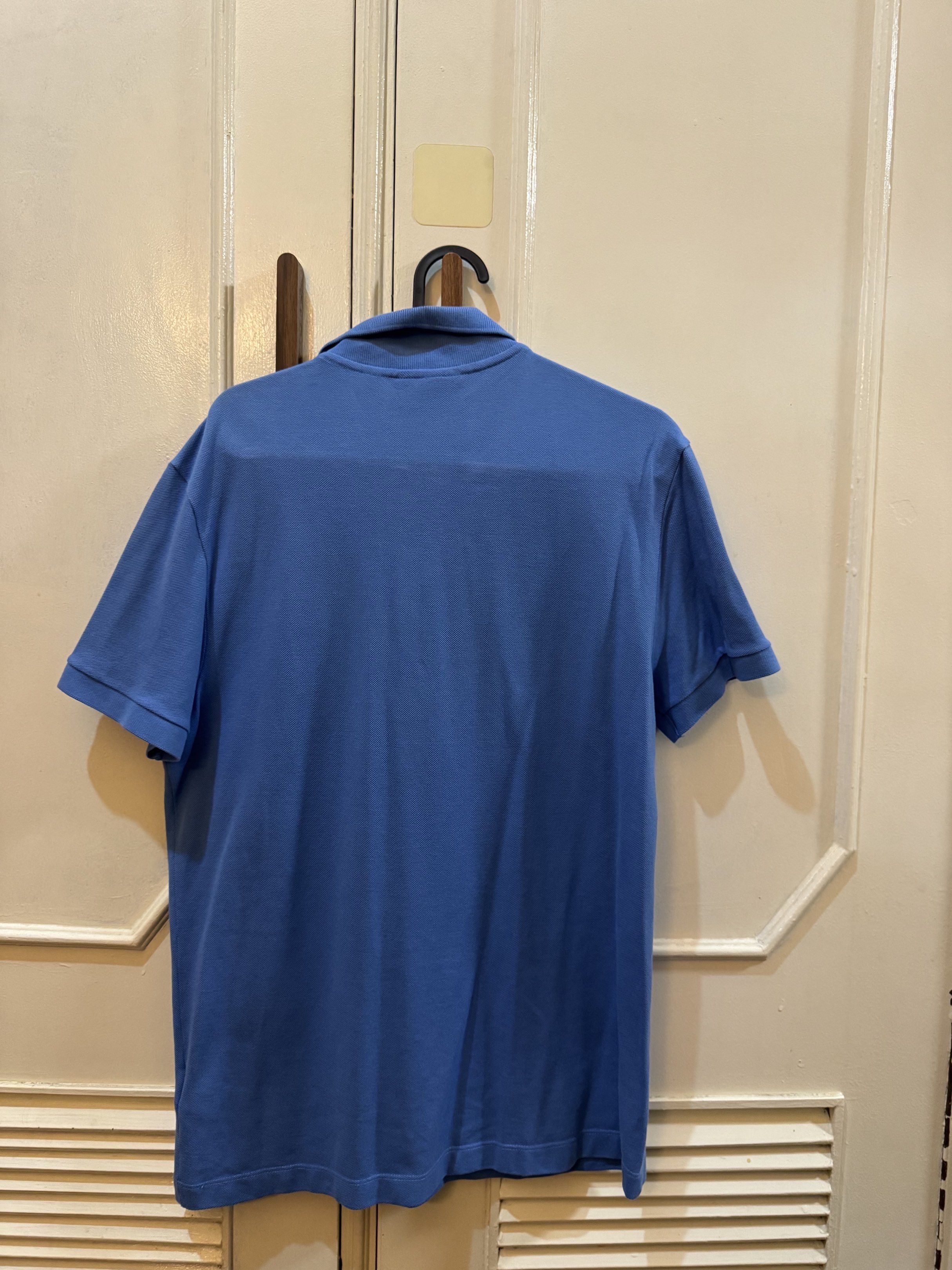 Lacoste Classic Fit Polo Shirt (Category: Tshirts & Polo Shirts ) located in Malabon City. Submitted by bryangeronimo (Listing ID 1417133818, Image 2). Description: - size 4 / M US -Blue Lacoste polo shirt - Short sleeves - Features Lacoste logo on chest - Vertical Lacoste graphic on front - Classic fit - Collared neckline with three-button placket - 19 1/2 X 25 1/2 inches .