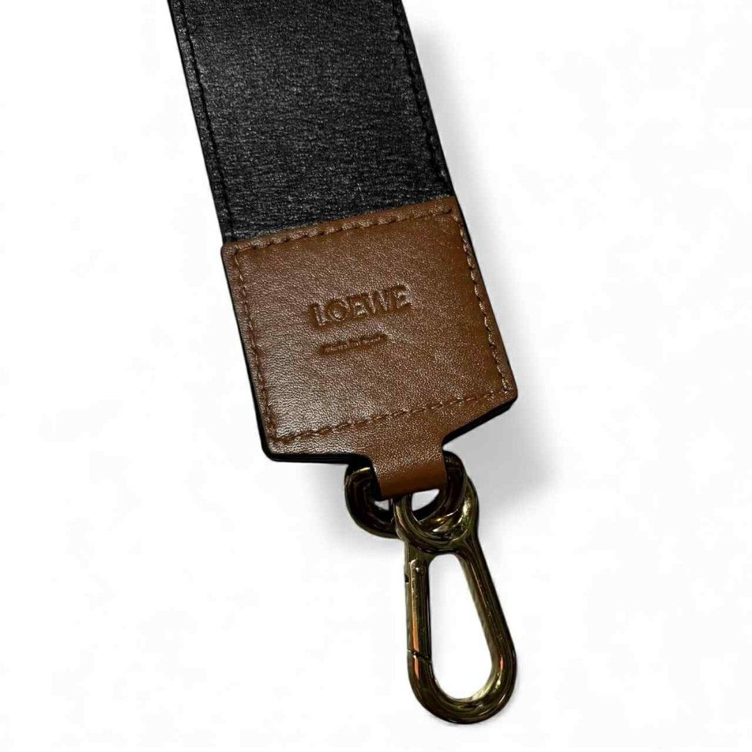 LOEWE Wide Leather Bag Strap – Black & Brown, Gold Hardware (authentic) (Category: Luxury Accessories) located in Cebu City. Submitted by westleygics18 (Listing ID 1417128138, Image 1). Description: LOEWE Wide Leather Bag Strap – Black & Brown, Gold Hardware (authentic) Excellent Condition Genuine leather Colors: Black strap with brown leather ends Hardware: Gold metal clasps with LOEWE engraving Width: 2 inches Length: 30 inches (end to end) Det