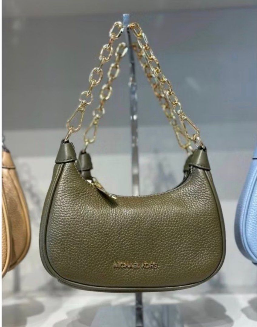 Michael Kors Cora Mini Shoulder Bag (Category: Luxury Bags & Wallets) located in Dasmarinas. Submitted by jc072727 (Listing ID 1417033107, Image 1). Description: - Michael Kors Cora Mini Shoulder Bag - Stylish olive green color - Gold chain strap - Includes an additional adjustable strap - Secure zip closure - Small interior compartment - Original price tag attached - Compact and chic design.