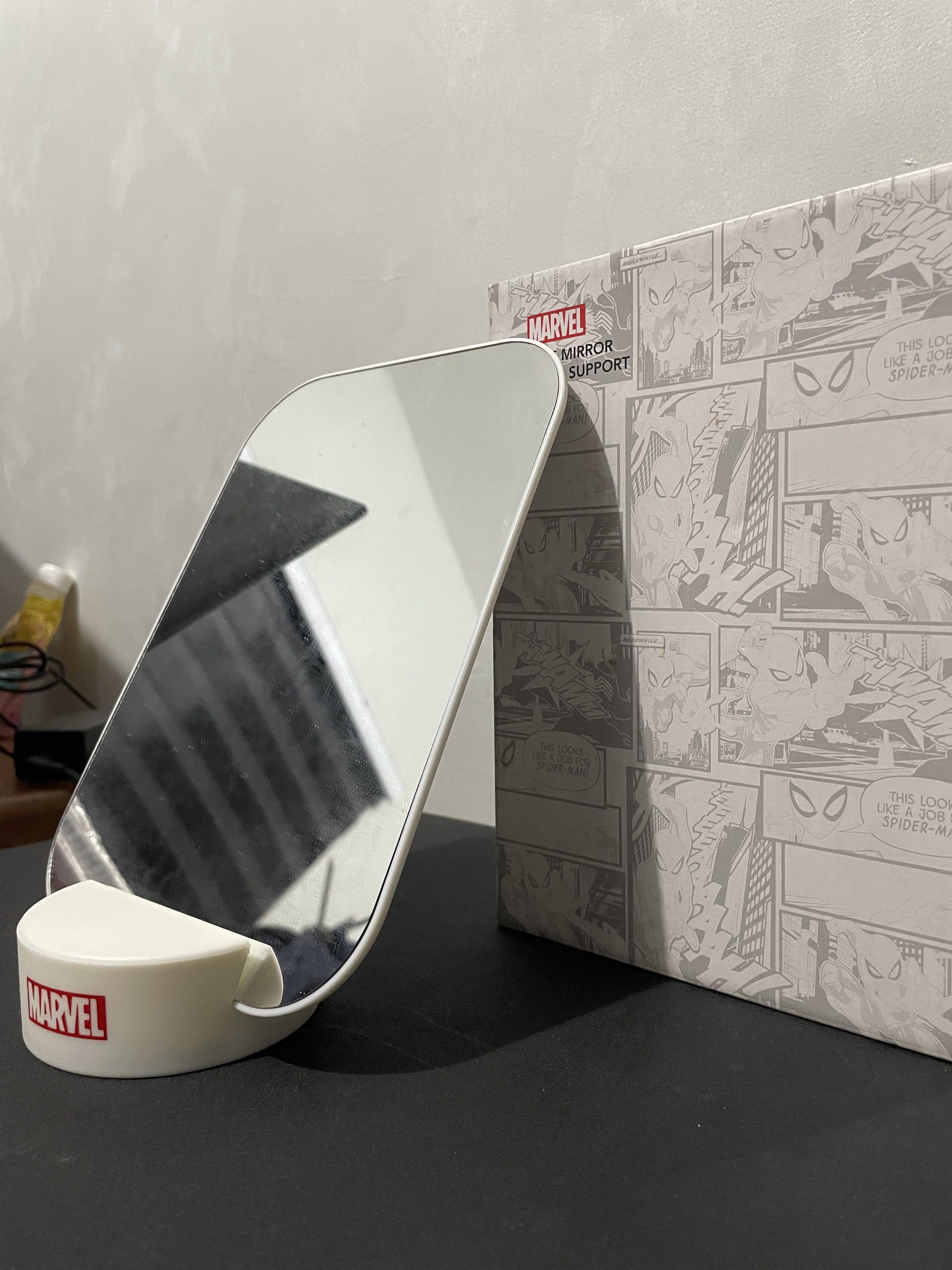 Miniso Marvel Mirror with Stand (Category: Mirrors) located in Taytay. Submitted by annequeen88 (Listing ID 1417146385, Image 2). Description: - Marvel mirror with a sleek white design - Rectangular shape with rounded corners - Includes a matching stand featuring the Marvel logo - Comes with the original box, showcasing a comic book design - Ideal for any Marvel enthusiast.