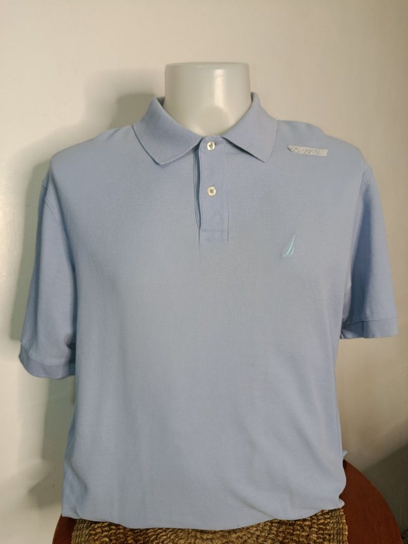 Nautica Polo Shirt - Light Blue (Category: Tshirts & Polo Shirts ) located in Tabaco. Submitted by chicpolos (Listing ID 1417210385, Image 1). Description: - Nautica polo shirt - Size: L - 22.5 - 23 x 31 - Color: Light Blue - Material: Cotton - Features: Embroidered Nautica logo, polo collar, three-button placket - Fit: Regular - Sleeves: Short.