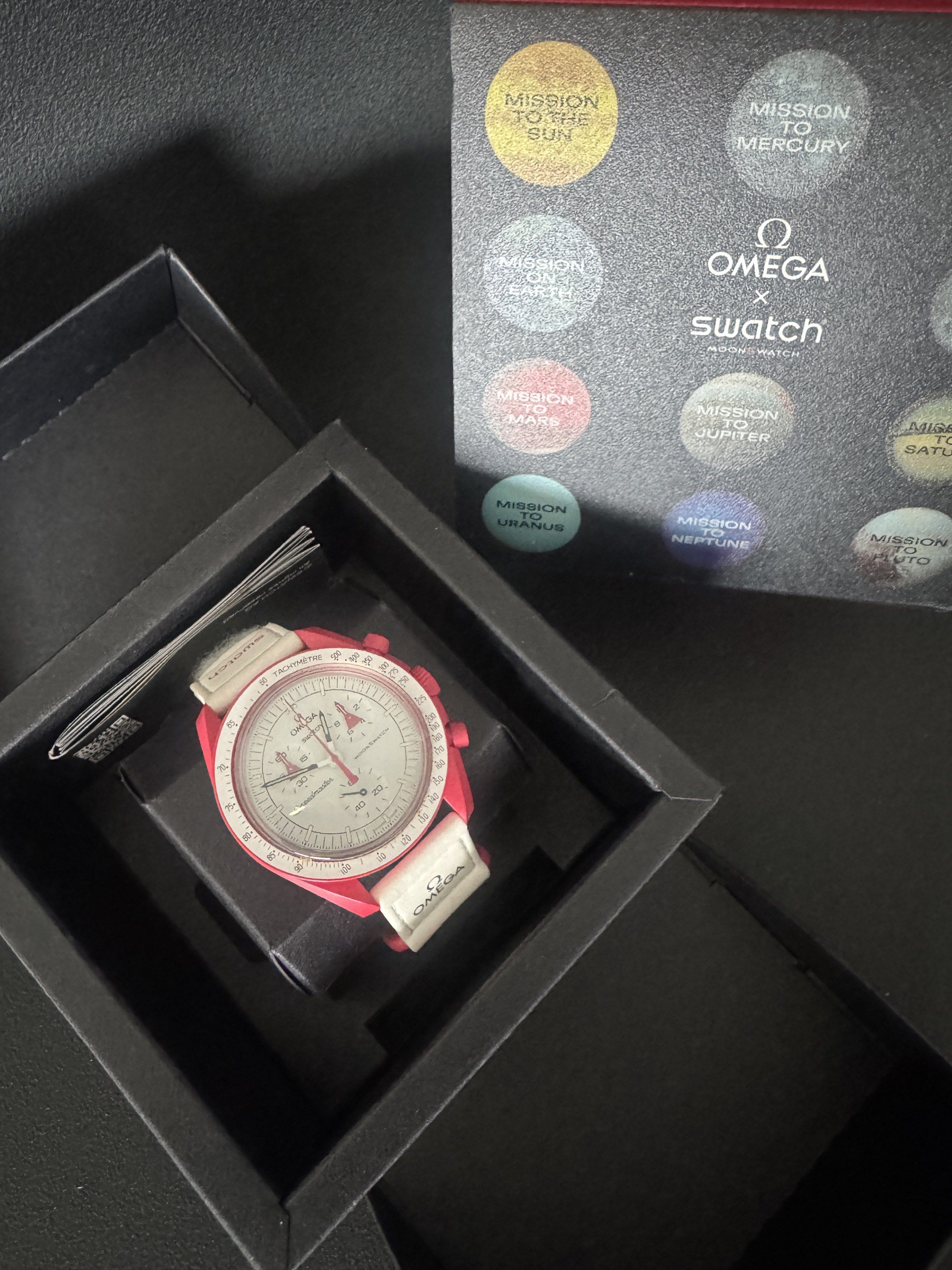 Omega x Swatch Mission to Mars (Category: Luxury Watches) located in Muntinlupa City. Submitted by 521collective (Listing ID 1417115748, Image 3). Description: - Omega x Swatch Mission to Mars watch - Red case - White dial - Chronograph functions - Includes original box and papers - White strap with Swatch logo - Part of the MoonSwatch collection Location: Greenbelt, Makati.