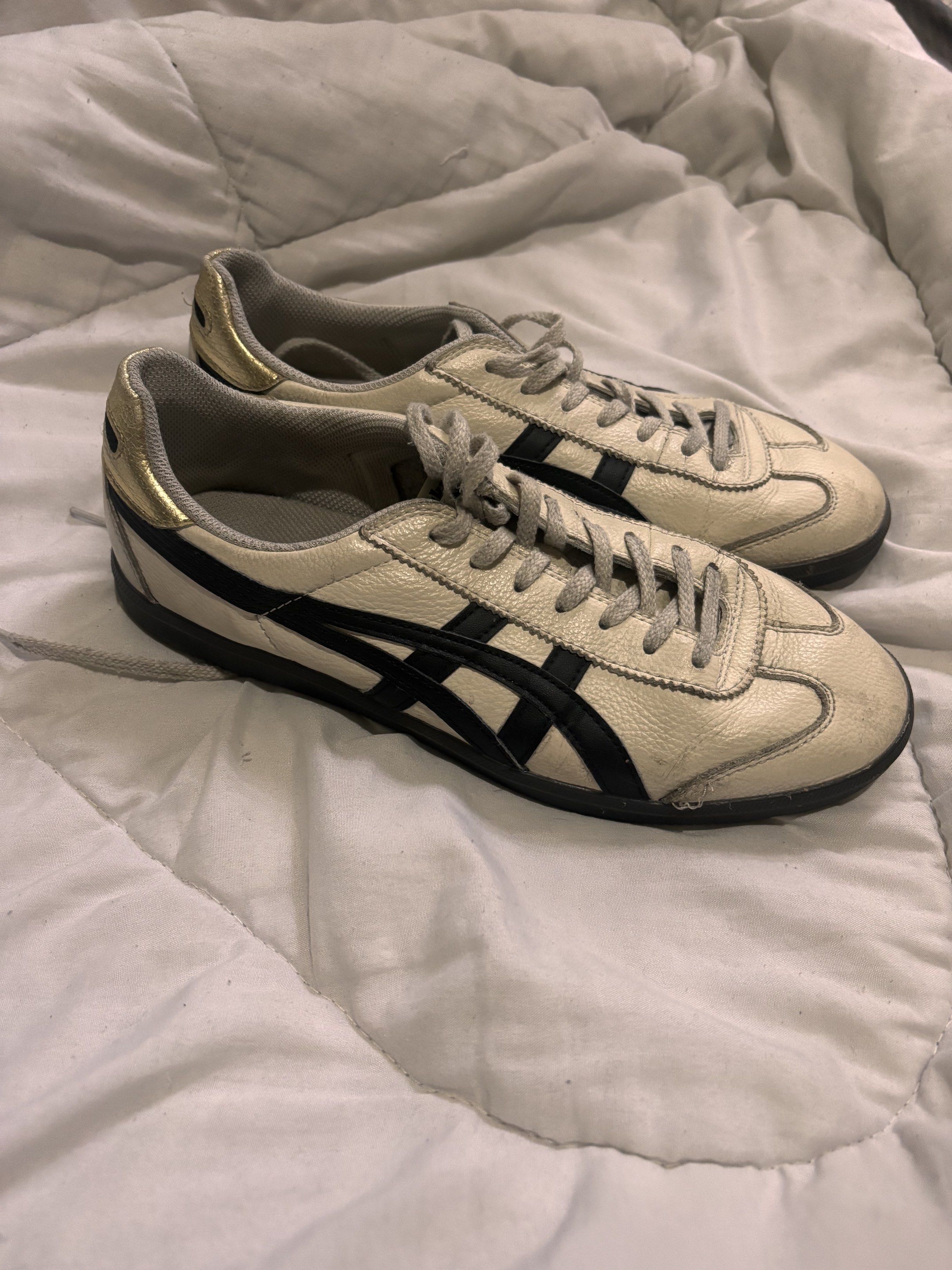 Onitsuka Tiger Mexico 66 Sneakers (Category: Casual Shoes) located in Paranaque City. Submitted by yawkonapo (Listing ID 1417065850, Image 1). Description: - Onitsuka Tiger Mexico 66 sneakers - Cream leather upper - Black stripes - Gold heel accents - Black soles - Lace-up closure - Retro design.