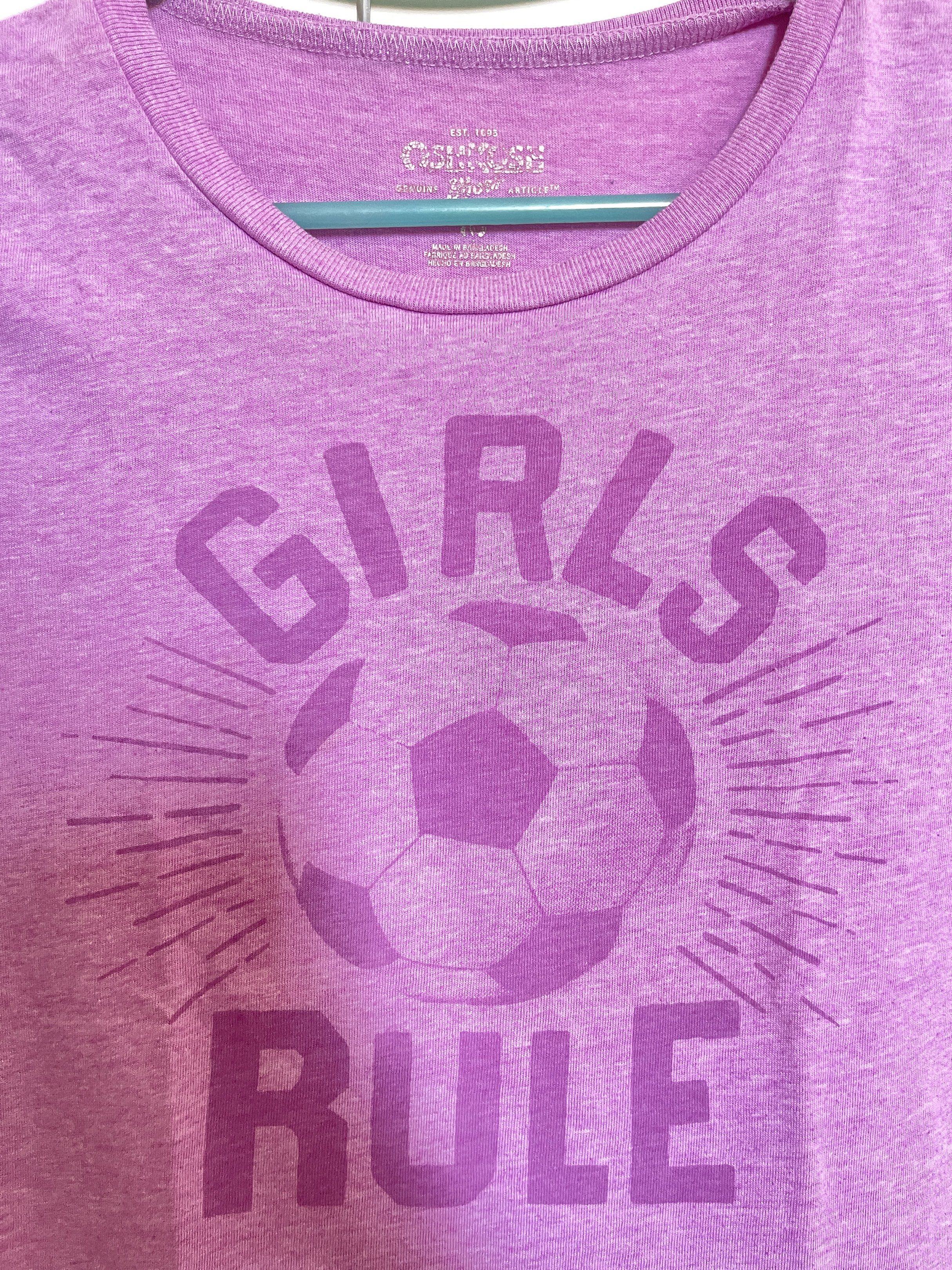 OshKosh - Kids T-shirt (Category: Babies & Kids Fashion) located in Manila. Submitted by closetlibraryph (Listing ID 1417090885, Image 2). Description: - OshKosh Girls Rule soccer graphic - Purple, short-sleeved shirt - Crew neck design - Soft and comfortable fabric - Casual wear appropriate - OshKosh brand visible.