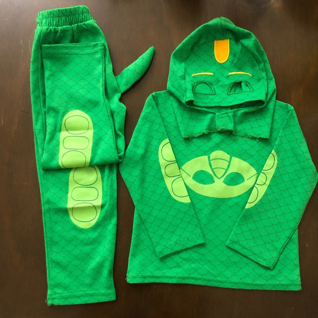Preloved PJ Masks Gecko Costume Set (Category: Babies & Kids Fashion) located in Marikina City. Submitted by petitechicph (Listing ID 1417206331, Image 1). Description: - PJ Masks Gecko costume set. - Includes a green hooded top with Gecko mask design. - Matching green pants with attached tail. - Perfect for dress-up or themed parties. - Inspired by the PJ Masks character Gecko..