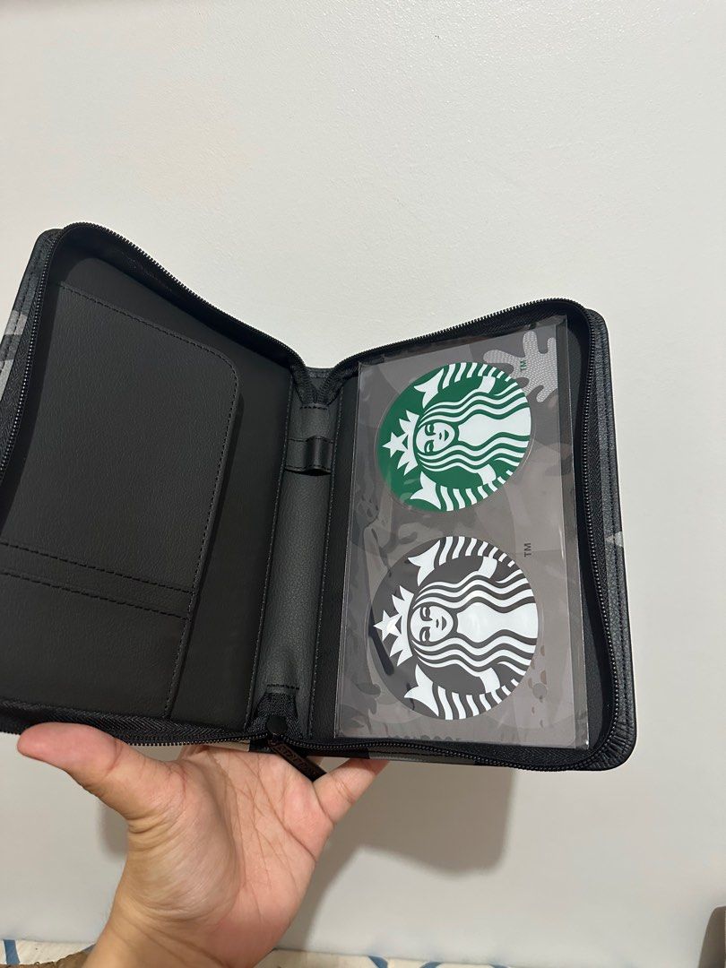 Starbucks Pouch 2026 with stickers and box (Category: Purses & Pouches) located in Manila. Submitted by jmalinea (Listing ID 1417054010, Image 3). Description: - Starbucks Pouch with unique design - Features Starbucks logo - Zippered closure - Includes card slots and clear pocket - Comes with two Starbucks stickers - In original box.