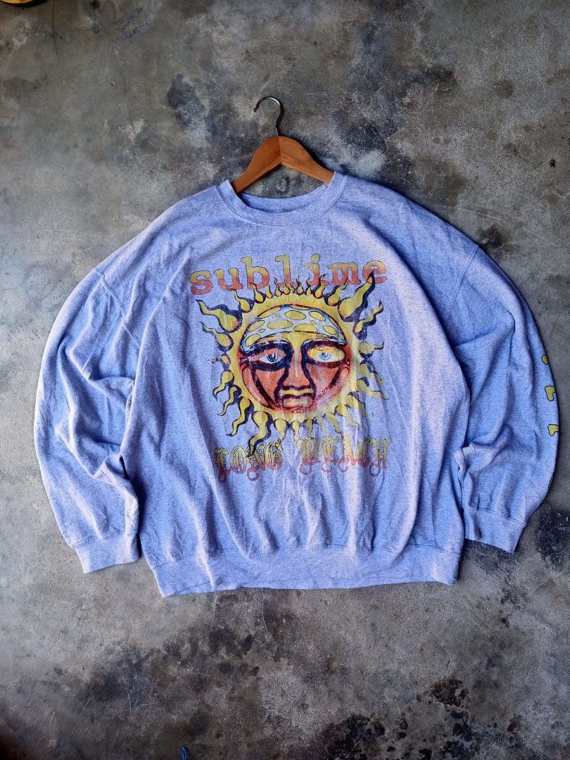 Sublime Band Sweatshirt (Category: Coats, Jackets and Outerwear) located in Mexico. Submitted by thereal.stuff (Listing ID 1417078851, Image 1). Description: Sublime Sweatshirt Width: 27 Lenght: 27 Color rate: 9/10 Good condition Issue(s): Not sure about print - Features band logo and sun graphic - Band name printed on sleeve - Size: S/M - Material: 50% cotton, 50% polyester.