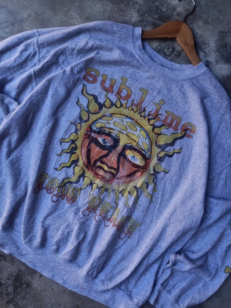 Sublime Band Sweatshirt (Category: Coats, Jackets and Outerwear) located in Mexico. Submitted by thereal.stuff (Listing ID 1417078851, Image 2). Description: Sublime Sweatshirt Width: 27 Lenght: 27 Color rate: 9/10 Good condition Issue(s): Not sure about print - Features band logo and sun graphic - Band name printed on sleeve - Size: S/M - Material: 50% cotton, 50% polyester.