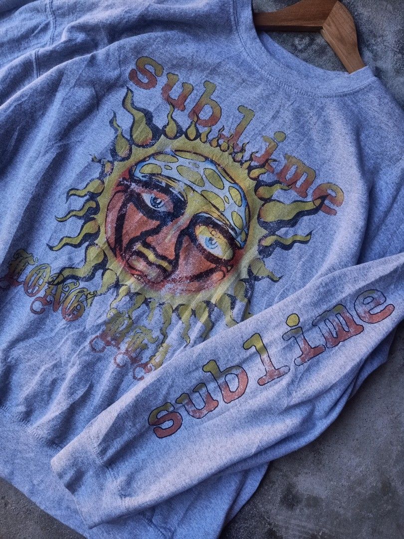 Sublime Band Sweatshirt (Category: Coats, Jackets and Outerwear) located in Mexico. Submitted by thereal.stuff (Listing ID 1417078851, Image 3). Description: Sublime Sweatshirt Width: 27 Lenght: 27 Color rate: 9/10 Good condition Issue(s): Not sure about print - Features band logo and sun graphic - Band name printed on sleeve - Size: S/M - Material: 50% cotton, 50% polyester.