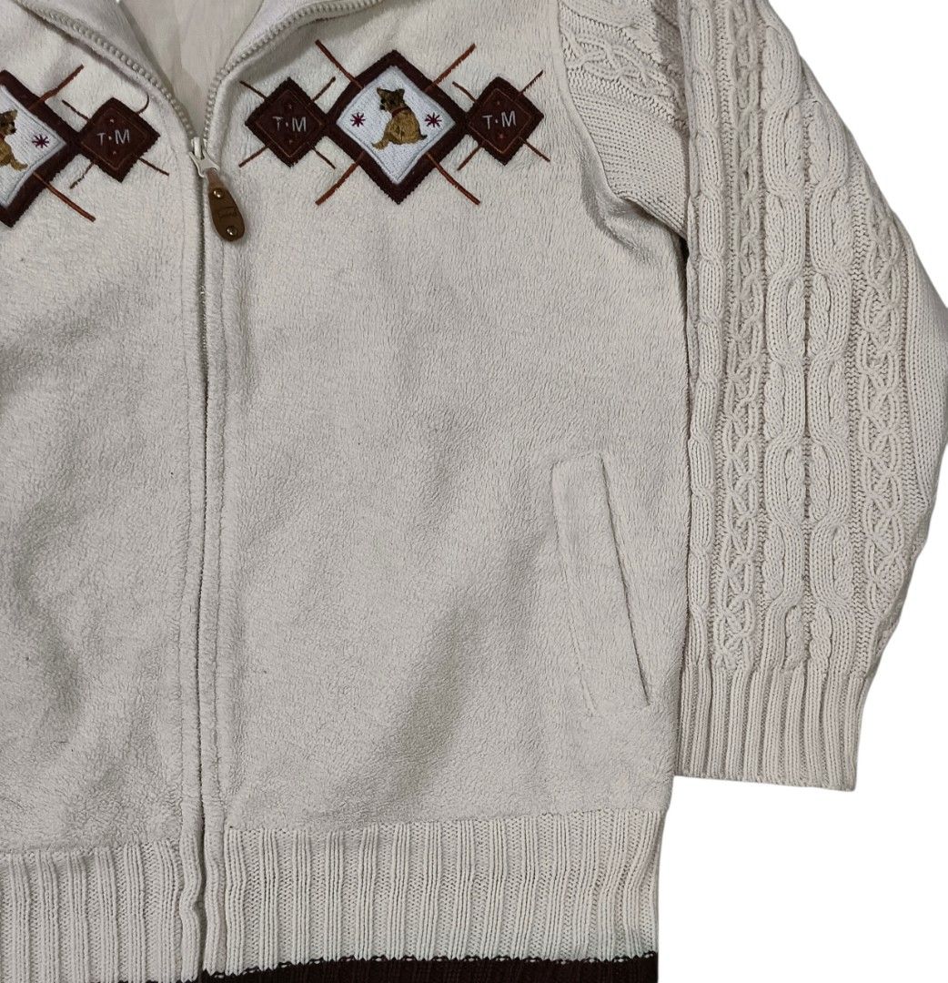 T-mind Embroidered Zip-Up Jacket (Category: Coats, Jackets and Outerwear) located in General Santos City (Dadiangas). Submitted by _jackeith (Listing ID 1417149543, Image 2). Description: Cream-colored zip-up jacket with brown accents. Features cable knit sleeves and a brown collar. The jacket has embroidered diamond patterns with a dog motif. It has a full zipper closure and two front pockets. The interior is lined with a light-colored fabric. T