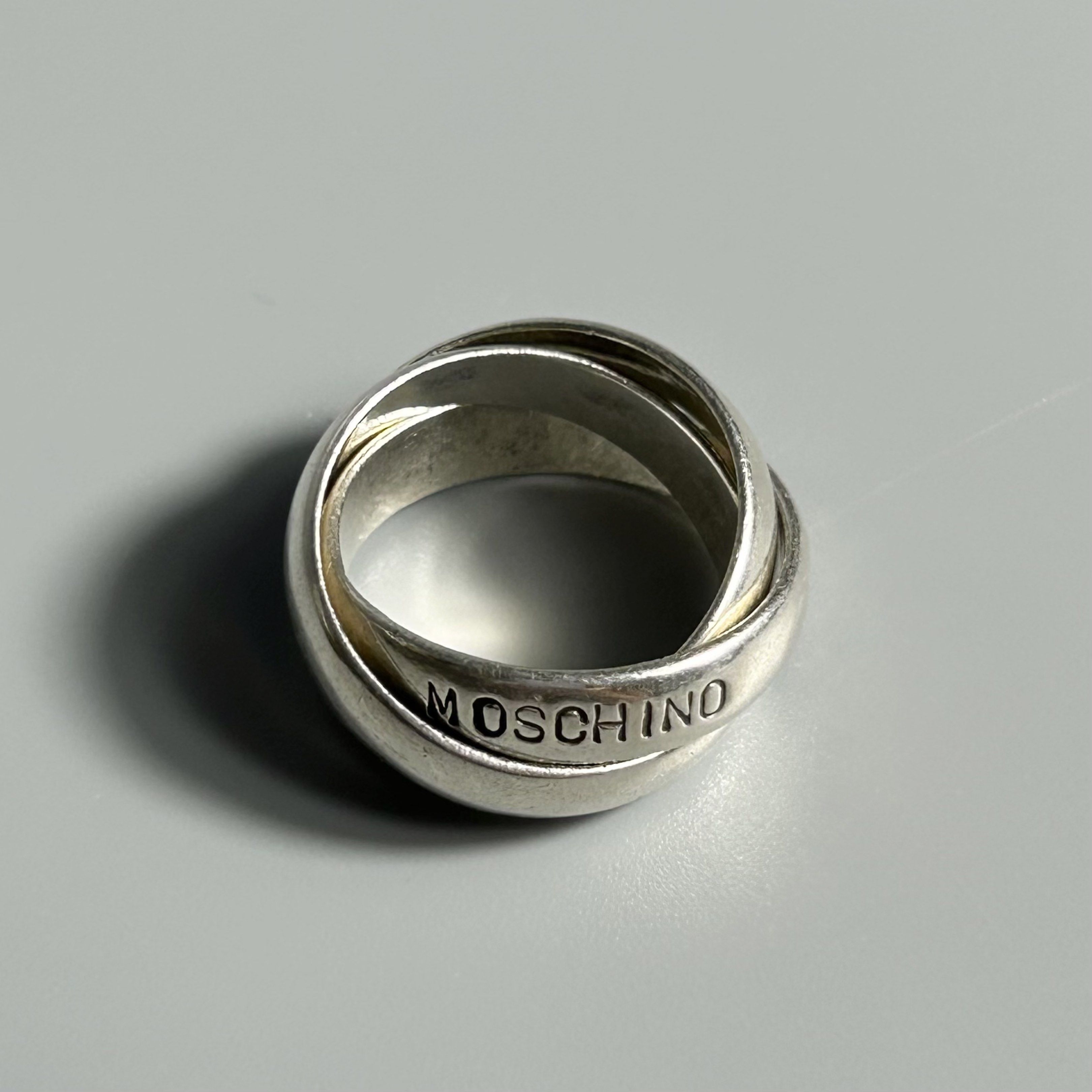 Vintage Moschino Triple Row Ring S925 (Category: Luxury Accessories) located in Cavite. Submitted by datsoretro (Listing ID 1417193536, Image 2). Description: Absolutely unique and rare S925 silver ring by Moschino. Size 6. It has been a favorite of mine ever since I bought it at an antique store in Japan. There are dirt and scratches visible. Very thick and has some weight to it. Unisex. .