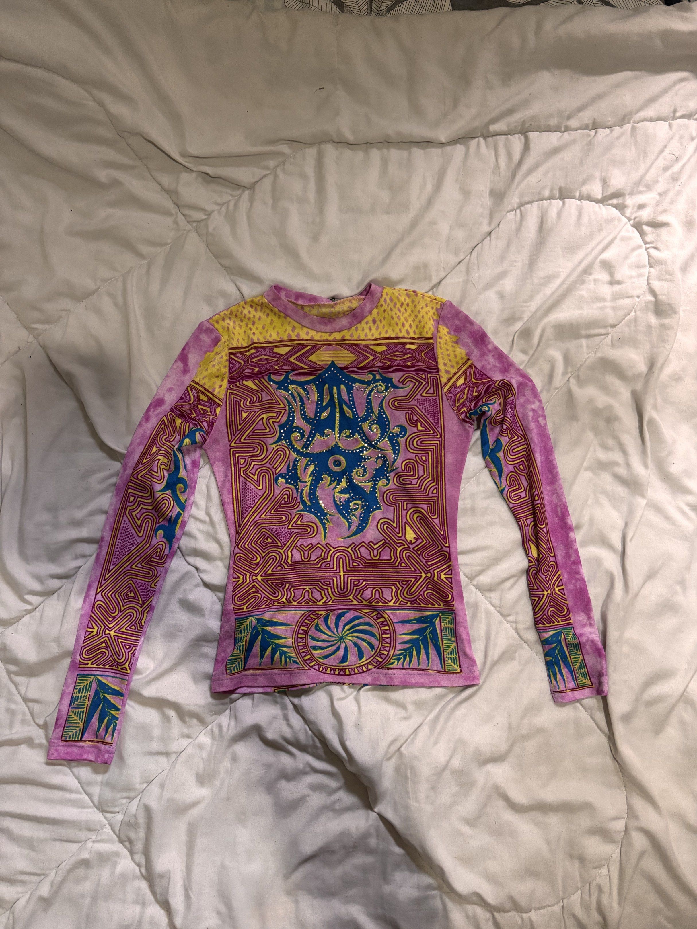 y2k long sleeves (Category: Longsleeves) located in Paranaque City. Submitted by yawkonapo (Listing ID 1417065533, Image 1). Description: - Long sleeve top - Unique, colorful print - Crew neck - Fitted silhouette - Intricate patterns in pink, yellow, and blue - Tie-dye effect on sleeves and back - Statement piece for your wardrobe.