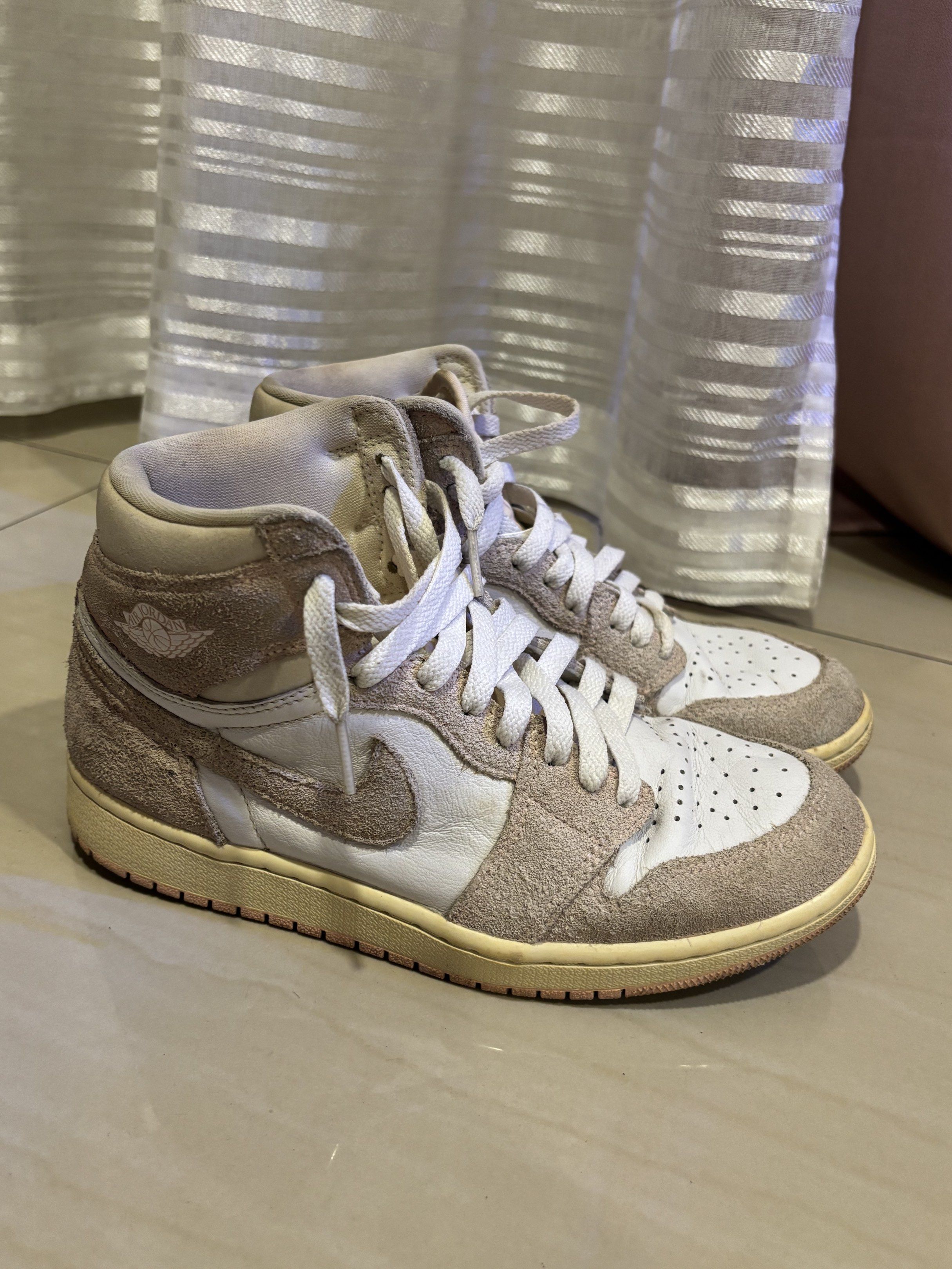 Air Jordan 1 High OG Neutral Grey (Category: Sneakers) located in Del Monte. Submitted by allydap (Listing ID 1417256096, Image 1). Description: - Air Jordan 1 High OG - Color: Neutral Grey and White - Upper: Suede and Leather - Iconic Nike Swoosh - High-top design with padded collar - Air Jordan logo detail - Light yellow sole - Size tag visible in images.