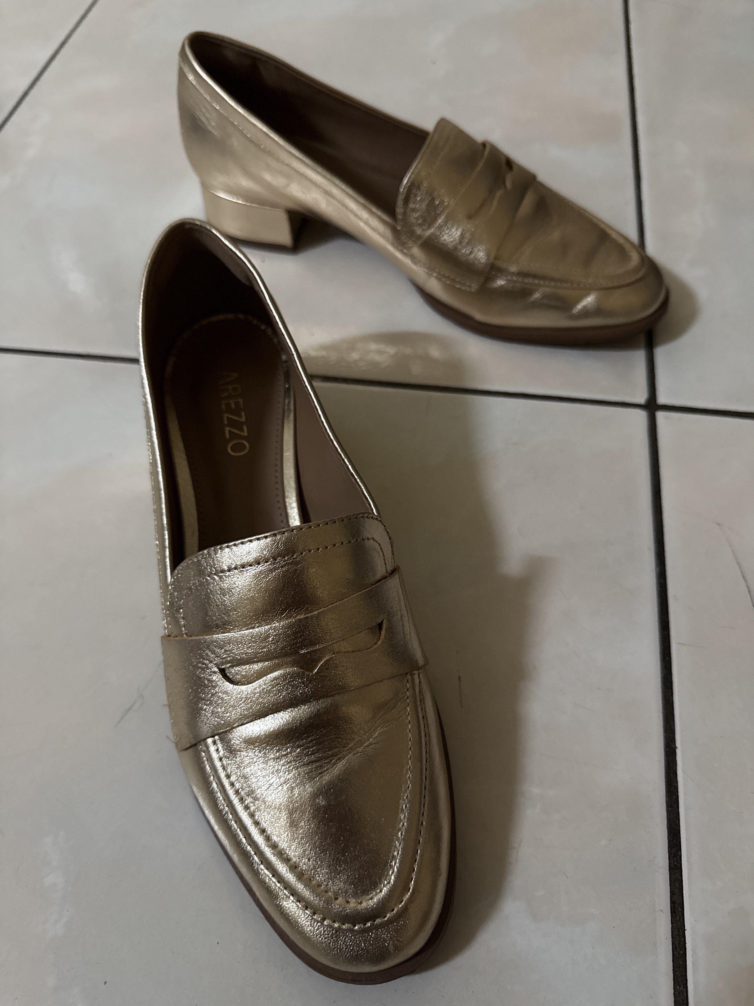 Arezzo Gold Loafers (Category: Loafers) located in Manila. Submitted by aesbl (Listing ID 1417363056, Image 2). Description: - Arezzo gold penny loafers - Classic design - Low block heel - Metallic gold finish - Leather material - Arezzo logo on insole.