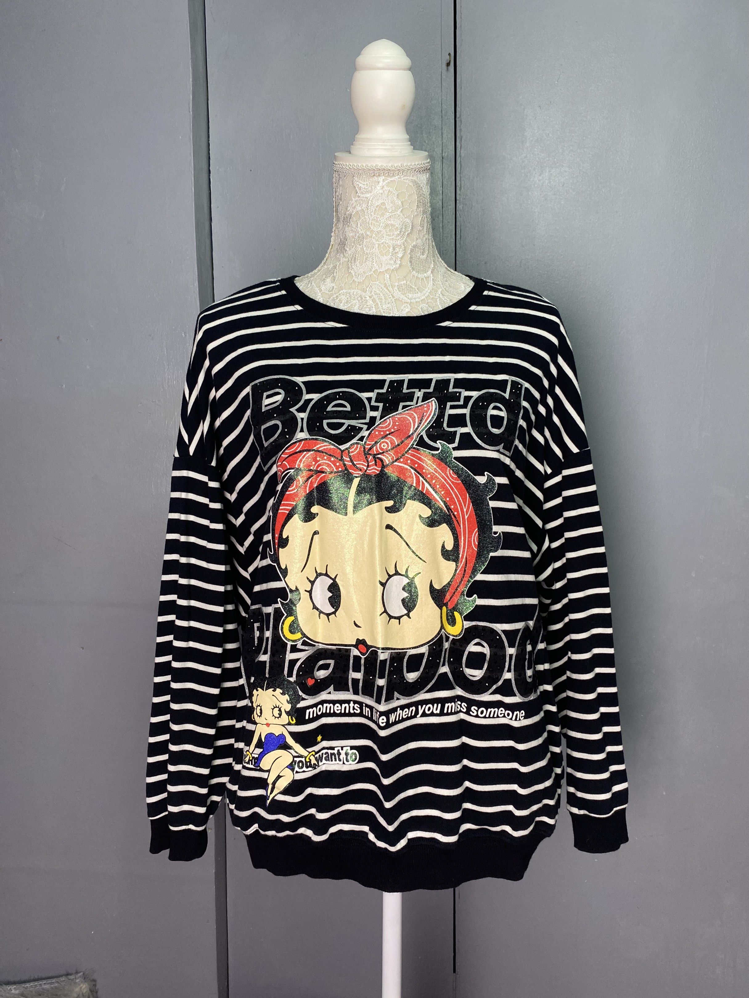 Betty Boop Striped Sweatshirt (Category: Longsleeves) located in Manila. Submitted by dignthrift (Listing ID 1417247013, Image 1). Description: - MLGYD Fashion sweatshirt - Black and white stripes - Betty Boop graphic on front - Graphic reads "Betto Plapoo" and "moments in life when you miss someone" - Crew neck - Long sleeves - Measurements in photos.