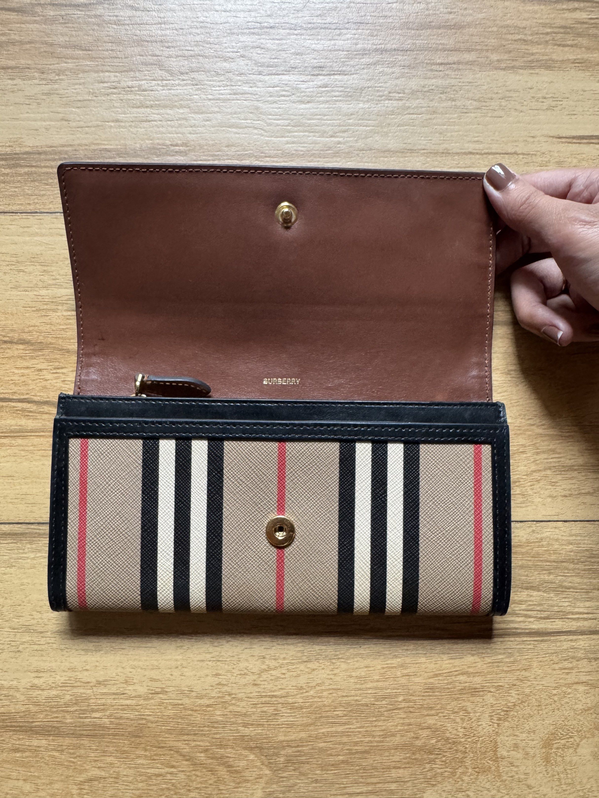 Burberry Check Long Wallet (Category: Luxury Bags & Wallets) located in Quezon City. Submitted by poyin88_ (Listing ID 1417257317, Image 2). Description: - Authentic Burberry wallet - Classic check pattern - Secure snap closure - Convenient zippered compartment - Luxurious brown leather interior - Multiple card slots - Includes Burberry logo - Comes with card.