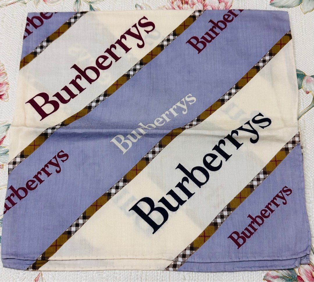 BURBERRY Classic Handkerchief (Category: Luxury Accessories) located in Manila. Submitted by rarefindsgallery (Listing ID 1417296477, Image 1). Description: Burberry Classic Handkerchief Size: 19.5”” x 19” Material: 💯 cotton Hand rolled hem Authentic Made in Japan 🇯🇵 This is a vintage Burberrys handkerchief/bandana featuring the iconic check pattern with repeated BURBERRYS text..