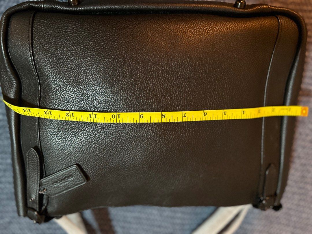 Coach Black Leather Tote Bag (Category: Tote Bags) located in Pasig City. Submitted by mixpicks (Listing ID 1417245247, Image 3). Description: - Brand new black leather Coach tote bag - Secure zip closure - Includes Coach tag - Interior pocket for organization - Comfortable double handles - Dimensions: Approximately 14 inches wide x 10 inches tall - Lined interior.