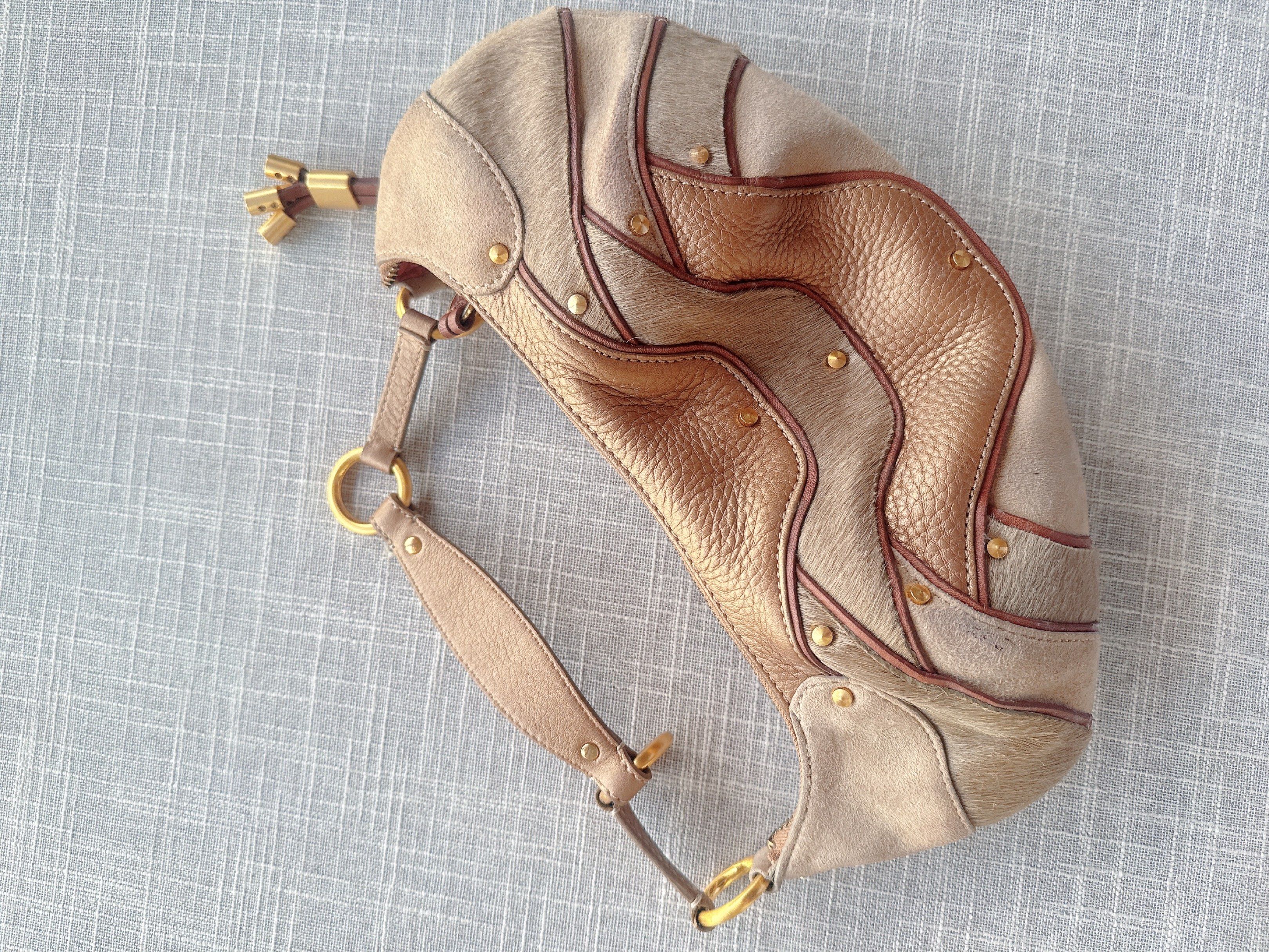Cole Haan Shoulder Bag (Category: Luxury Bags & Wallets) located in Lucena. Submitted by fashioncult.ph (Listing ID 1417282510, Image 3). Description: - Cole Haan shoulder bag - Unique design with mixed textures and colors - Secure zip closure - Comfortable shoulder strap - Elegant gold-tone hardware - Contrasting interior lining - Includes a decorative tassel.