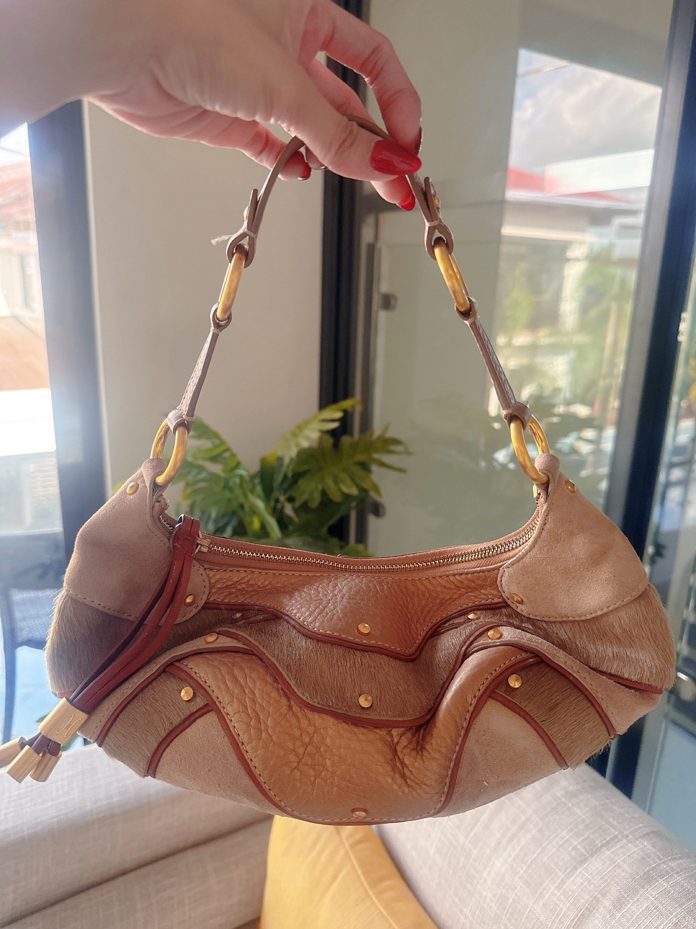 Cole Haan Shoulder Bag (Category: Luxury Bags & Wallets) located in Lucena. Submitted by fashioncult.ph (Listing ID 1417282510, Image 1). Description: - Cole Haan shoulder bag - Unique design with mixed textures and colors - Secure zip closure - Comfortable shoulder strap - Elegant gold-tone hardware - Contrasting interior lining - Includes a decorative tassel.