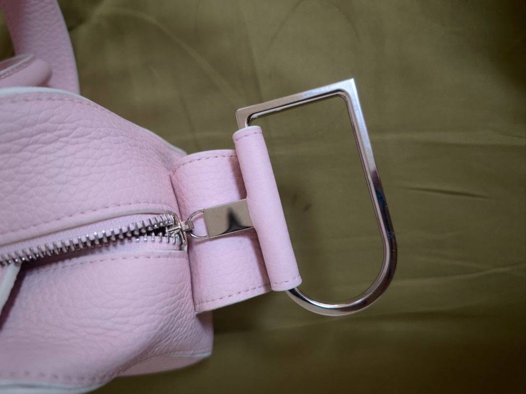 Delvaux Cool Box Mini Handbag (Category: Luxury Bags & Wallets) located in Valenzuela. Submitted by neromiii (Listing ID 1417322871, Image 3). Description: Rare color Authentic Delvaux Cool Box Mini In super pretty pink color 😍🩷🩷 kaya hard to let go Hairline scratches lang sa hardware, barely noticeable Minor flaws sa button ng handle -pls. See pics Leather is very soft Overall still in very good condition Inclusions: Bag Strap Free extra pink