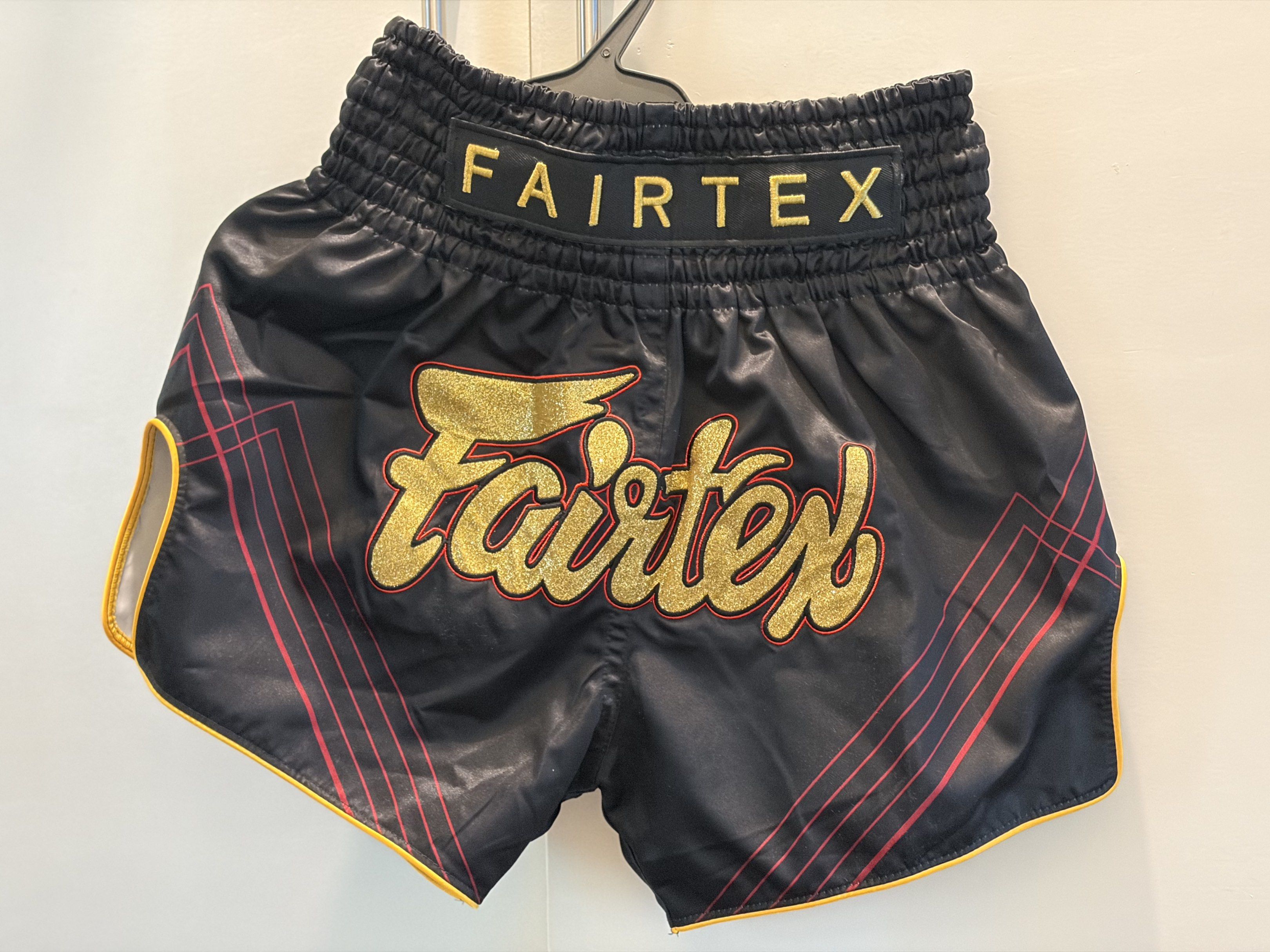 Fairtex Muay Thai Shorts XS (Category: Shorts) located in Makati City. Submitted by iirys (Listing ID 1417229166, Image 3). Description: - Authentic Fairtex Muay Thai shorts - Color: Black with gold, red, and yellow accents - Features Fairtex logo - Size: XS - Made in Thailand. -Good as new .