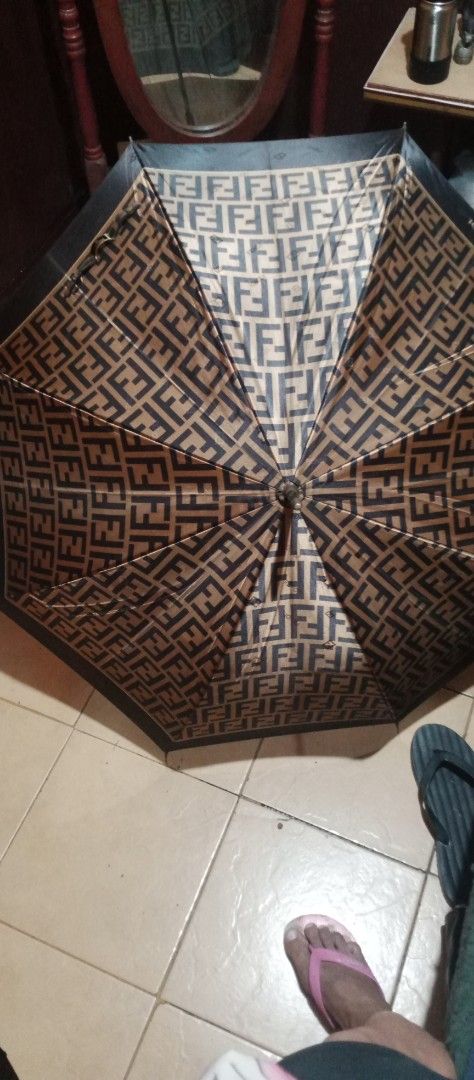 Fendi Umbrella (Category: Umbrellas) located in Makati City. Submitted by cd910625 (Listing ID 1417268473, Image 1). Description: - Authentic Fendi umbrella - Features iconic FF logo - Black handle and trim - Foldable design - Fendi logo visible - Includes matching strap.