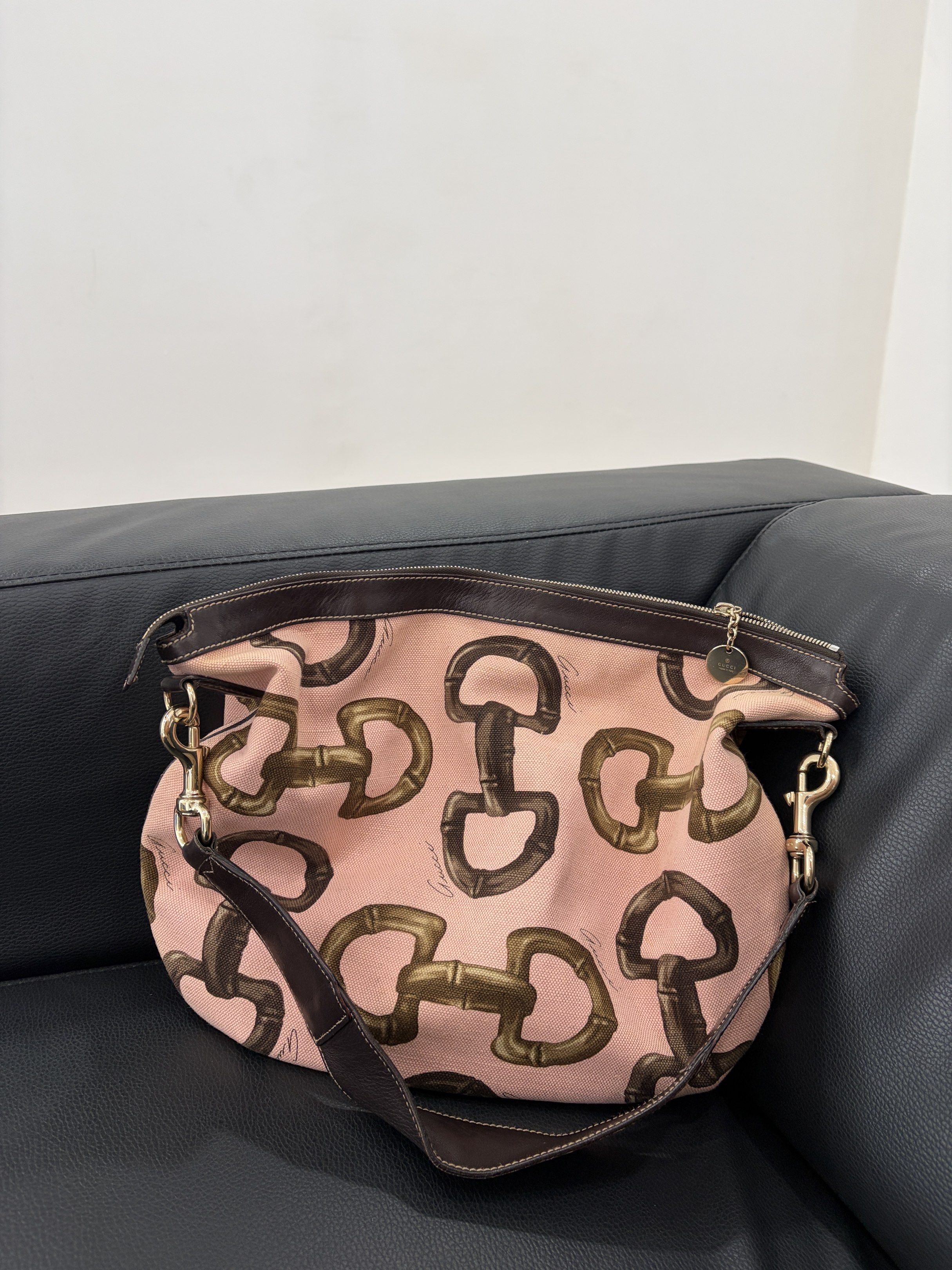 Gucci Pink Canvas Hobo Shoulder Bag (Category: Luxury Bags & Wallets) located in Vigan. Submitted by longliveolive (Listing ID 1417238747, Image 1). Description: - Gucci shoulder bag - Pink canvas exterior with equestrian bit pattern - Brown leather shoulder strap and trim - Zipper closure - Brown fabric interior lining - Serial number: 154401 205011.
