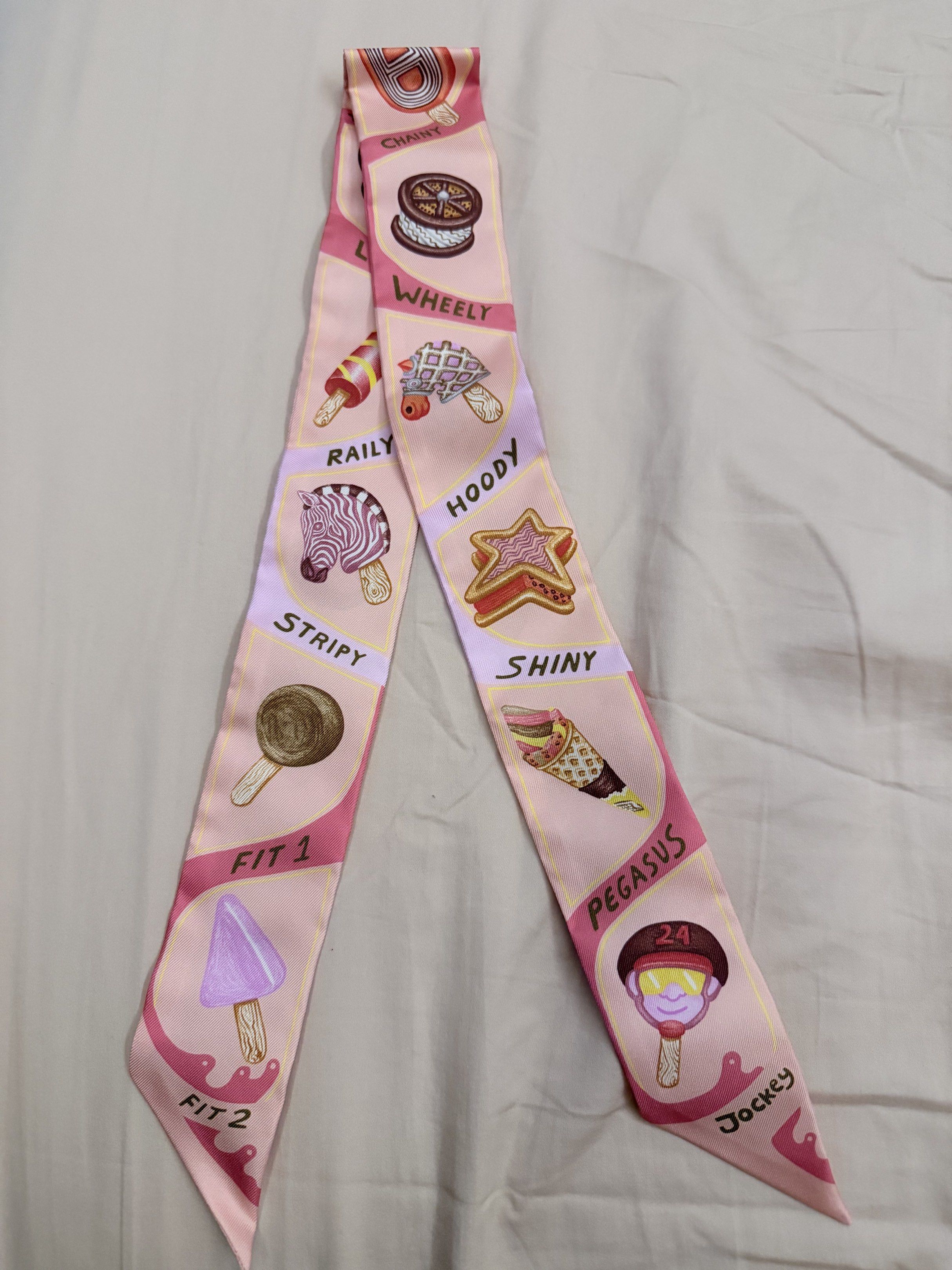 Hermes Ice Cream Twilly Scarf (Category: Scarves) located in Manila. Submitted by puremountain-39f9e0 (Listing ID 1417297590, Image 1). Description: - Authentic Hermes Twilly scarf - Features a colorful ice cream design - Comes with original orange box and ribbon - Long, narrow shape for versatile styling - Playful ice cream illustrations Can provide a photo of the receipt.