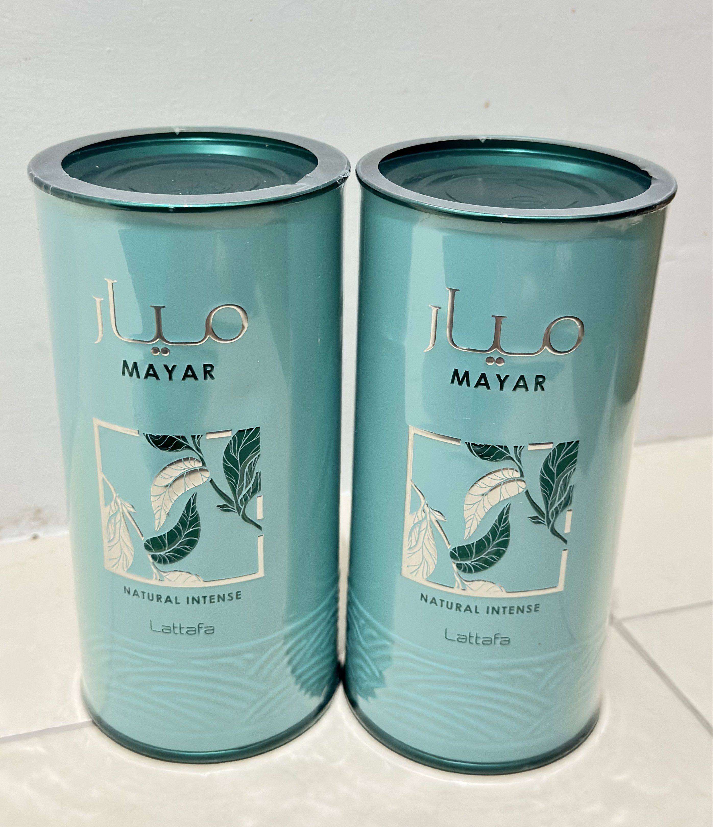 Lattafa Mayar Natural Intense Perfume (Category: Fragrance & Deodorants) located in General Mariano Alvarez. Submitted by donnabeys (Listing ID 1417248389, Image 1). Description: - Two bottles of Lattafa Mayar Natural Intense perfume. - Cylindrical bottles with a teal and gold design. - Authentic Lattafa product. - Each bottle includes a cap and label. - Packaging clearly displays the brand name and "Natural Intense"..