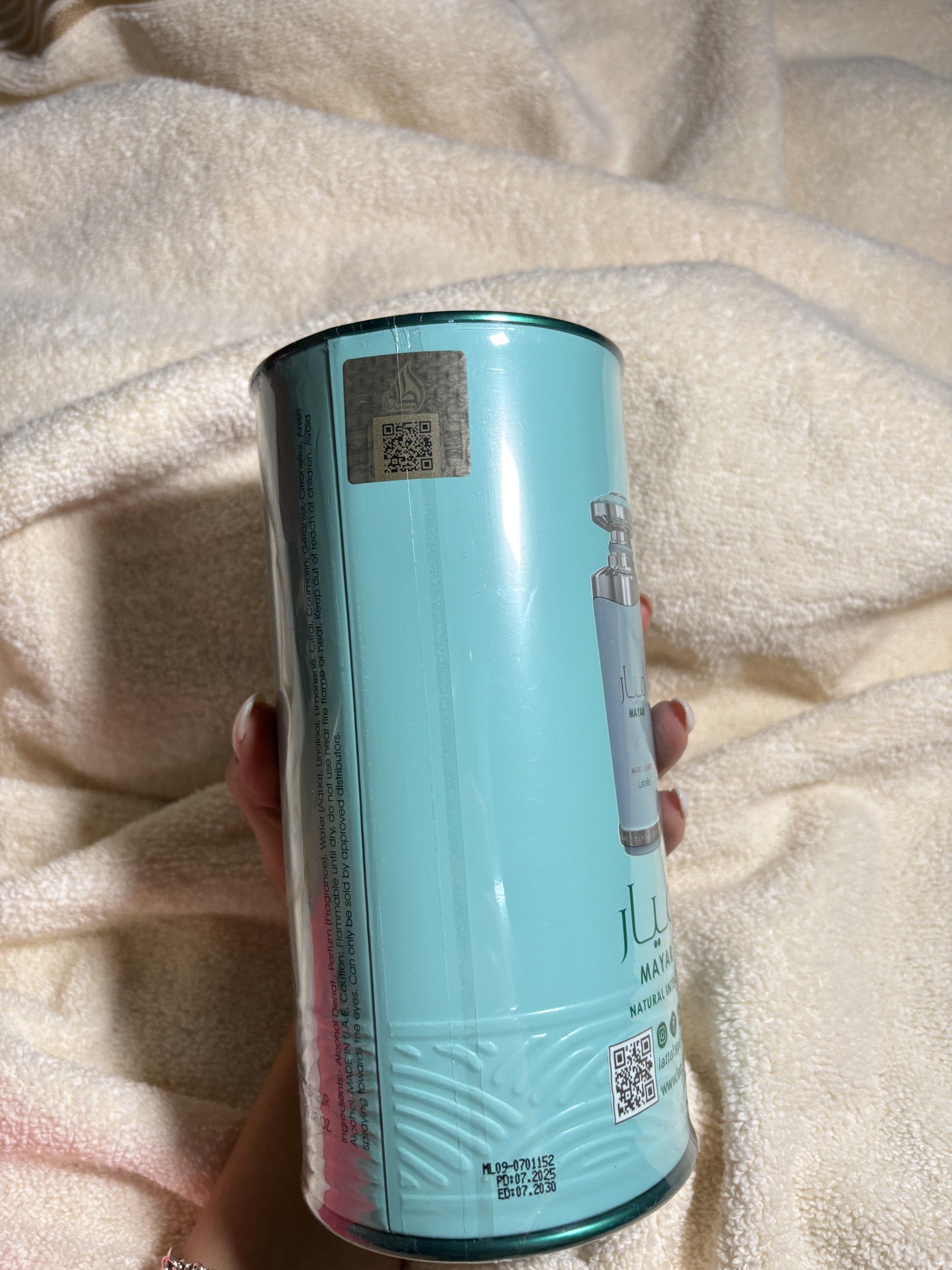 Lattafa Mayar Natural Intense Perfume (Category: Fragrance & Deodorants) located in Quezon City. Submitted by ysiocoxx (Listing ID 1417368538, Image 3). Description: - Lattafa Mayar Natural Intense perfume - Light teal packaging with silver accents - Cylindrical bottle - Comes in original packaging - Features a QR code - Includes brand's social media handles.