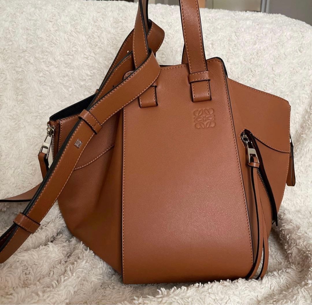Loewe Hammock in Tan Small (Category: Luxury Bags & Wallets) located in Muntinlupa City. Submitted by manikascloset (Listing ID 1417309481, Image 1). Description: - Authentic Loewe Puzzle Bag - Stunning tan color - Unique geometric design - Secure zip closure - Includes a detachable shoulder strap - Comfortable top handles for hand carry - Spacious interior for daily essentials - Features the iconic Loewe logo - Ideal for everyday use.