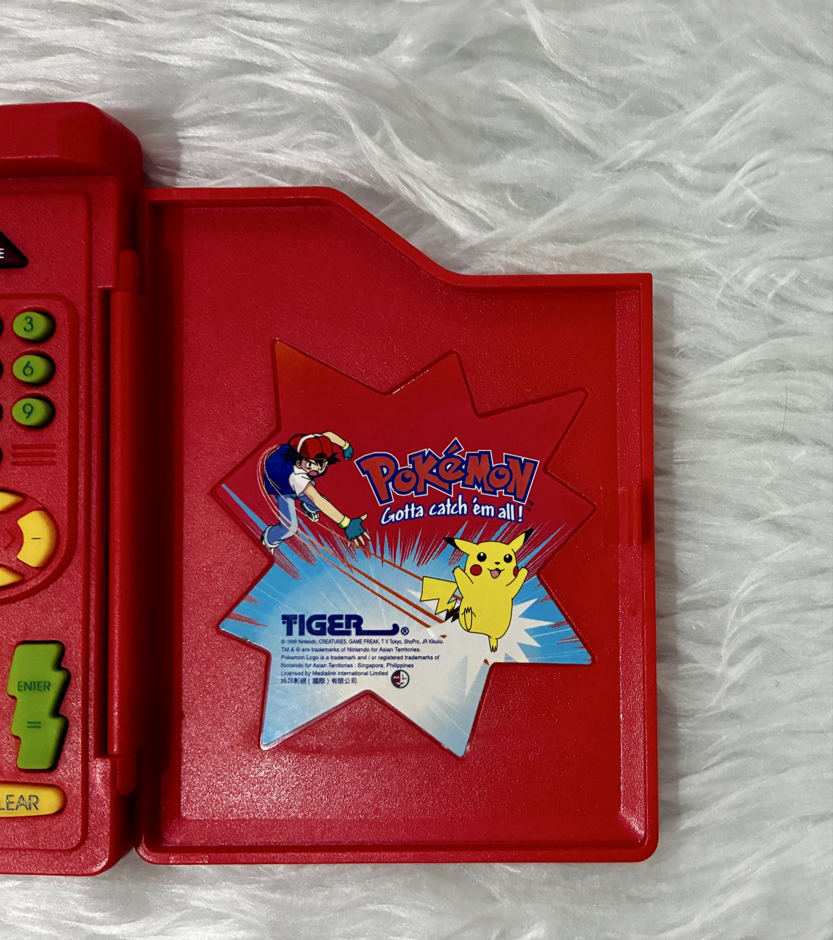 Preloved Original Pokemon Pokedex by Tiger (Category: Character Goods) located in Quezon City. Submitted by inmycloset03 (Listing ID 1417304902, Image 3). Description: - Preloved Original Pokemon Pokedex by Tiger - Classic red design - Features the iconic Pokemon logo and characters - Fully functional screen and buttons - A great addition to any Pokemon collection - Perfect for fans of all ages ** ISSUE upper left side screen dead pixel see photo
