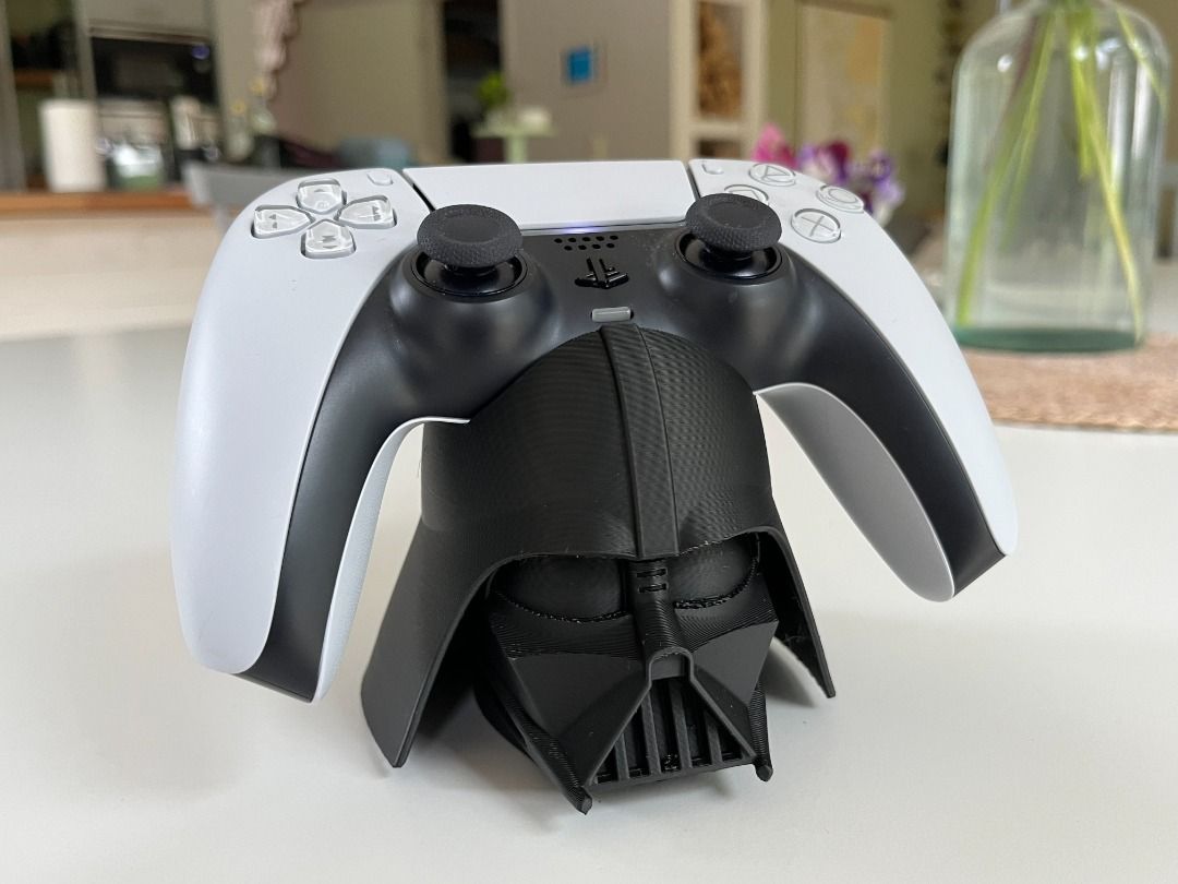 PS5 Controller Stand (DualSense) – Darth Vader Helmet Display | Collector‑Style Holder (Category: Controllers) located in Mandaluyong City. Submitted by heyitslaaaance (Listing ID 1417219697, Image 3). Description: Bring the dark side to your gaming setup with this Darth Vader‑themed PS5 DualSense Controller Stand. Perfect for collectors, Star Wars fans, and anyone wanting a unique centerpiece for their desk or display shelf. Designed to securely